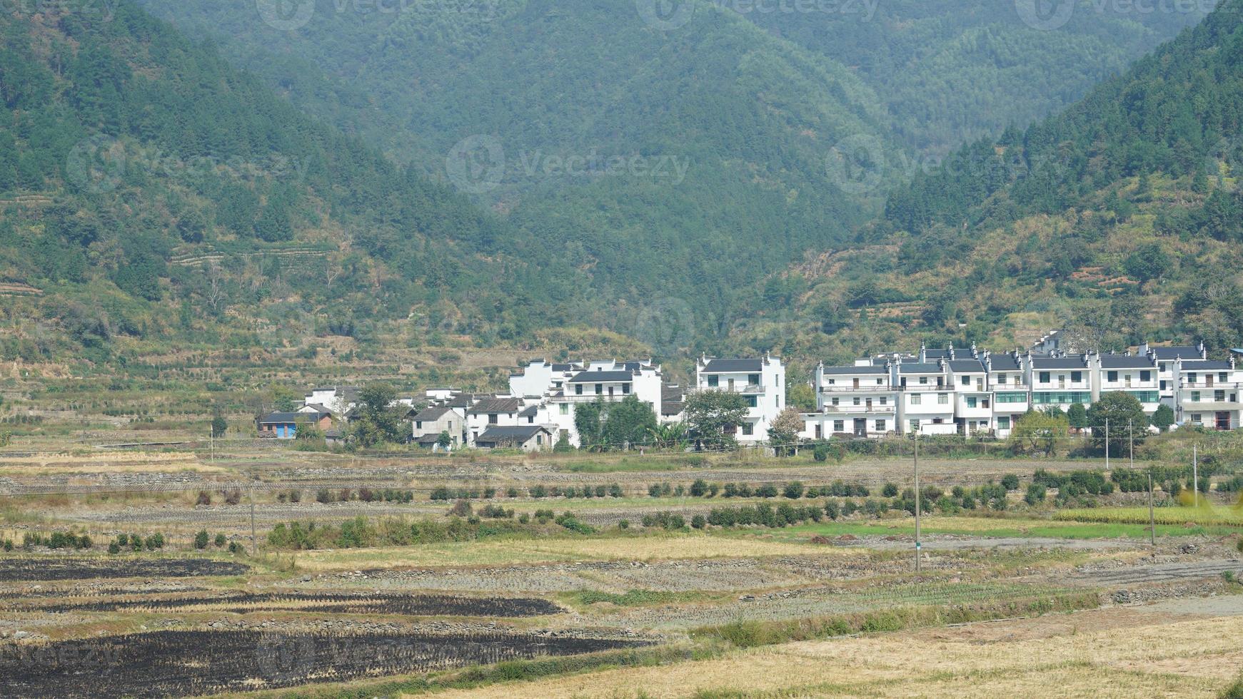 The beautiful traditional Chinese village view with the classical architecture and fresh green trees as background photo