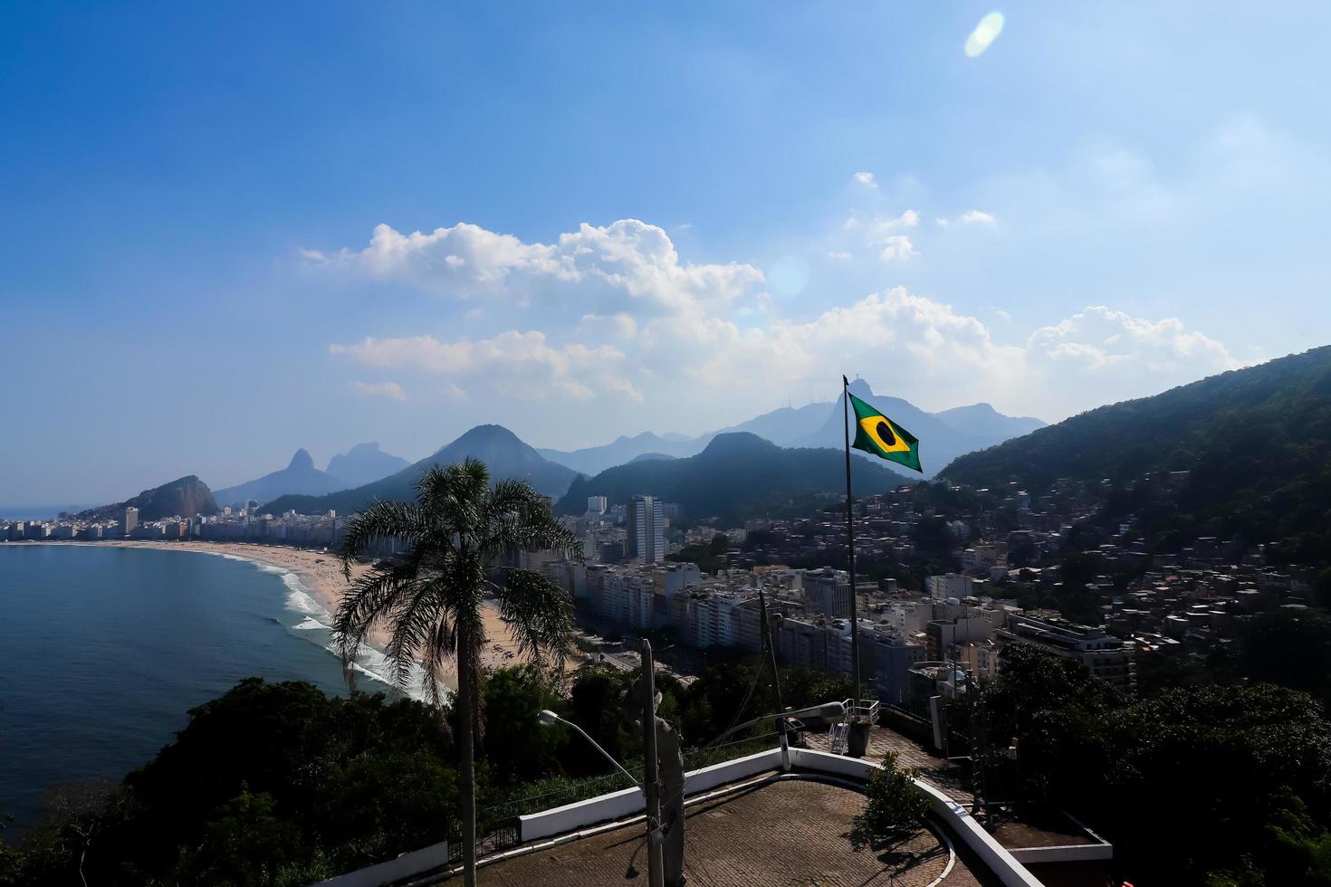 Rio de Janeiro, RJ, Brazil, 2022 - Brazil national flag and Copacabana Beach - view from Duque de Caxias Fort, Leme neighborhood photo