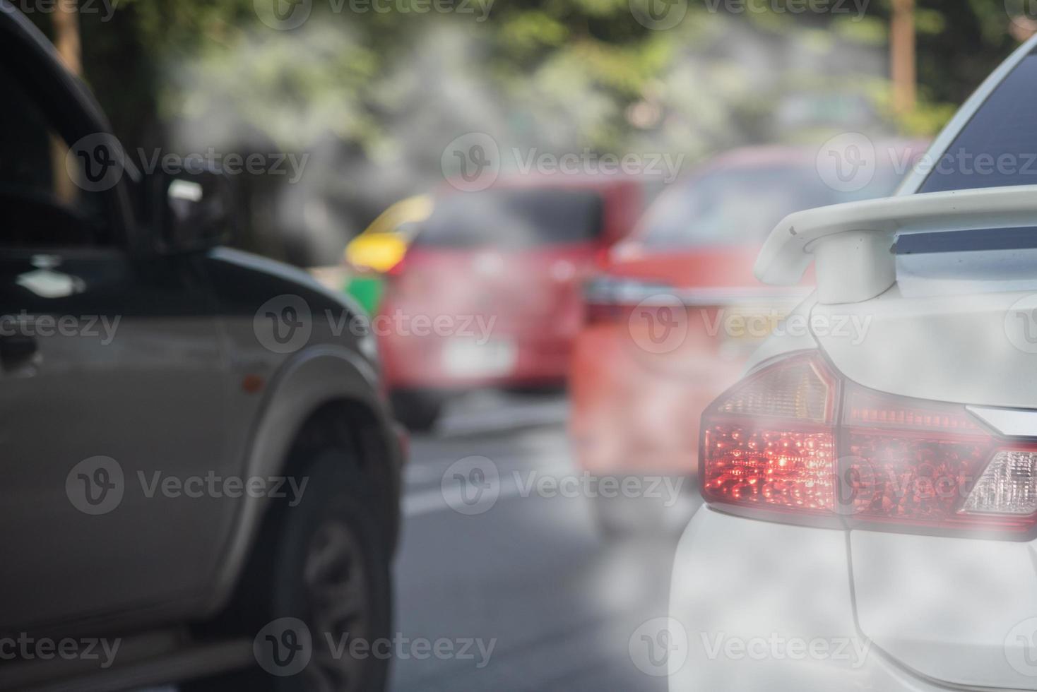 Air pollution from car exhaust smoke traffic in the city. Reducing global warming pollution and carbon dioxide from engine combustion. photo