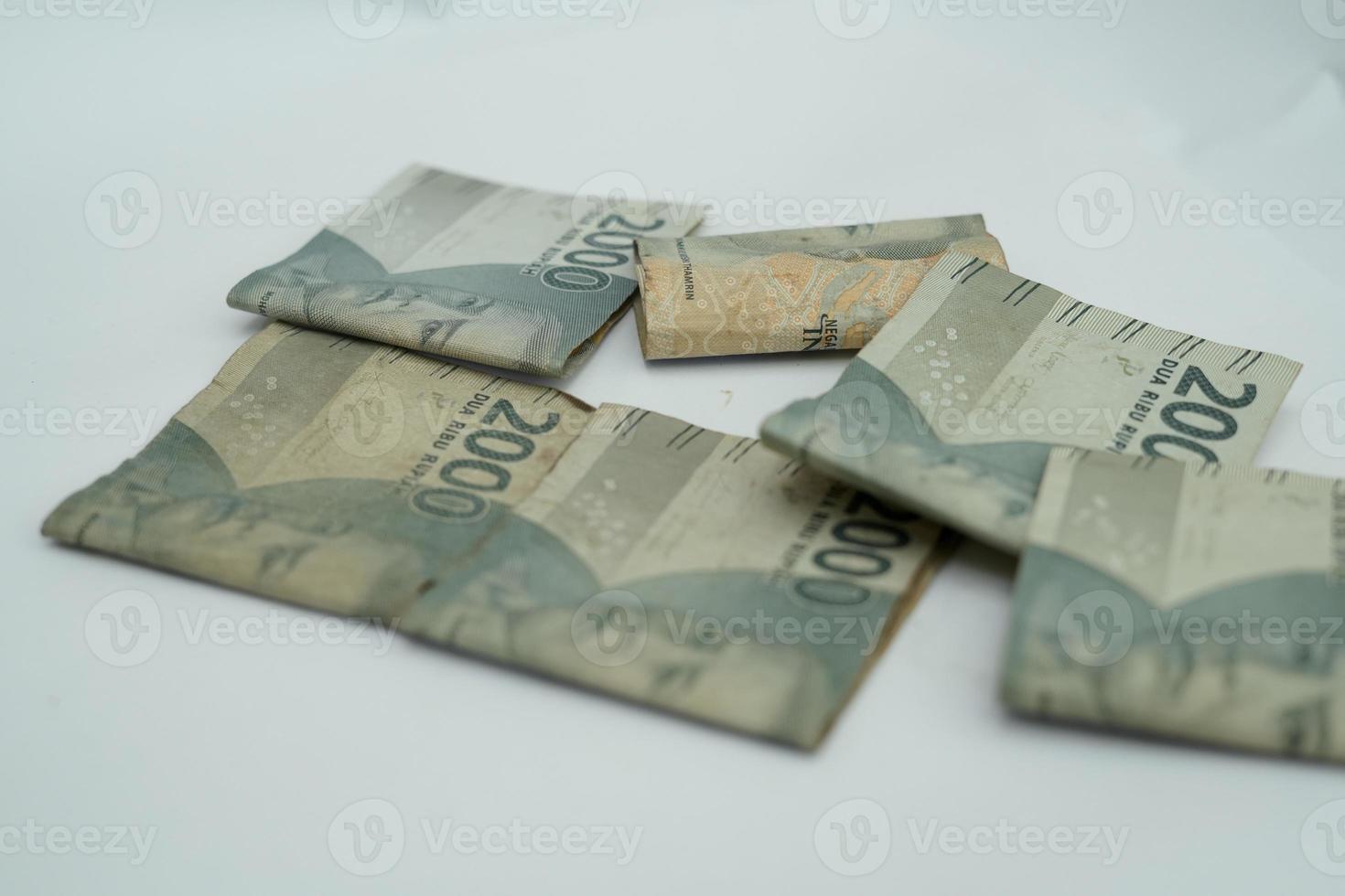 A collection of Indonesian currencies with a value of 2000 rupiah on a white background photo