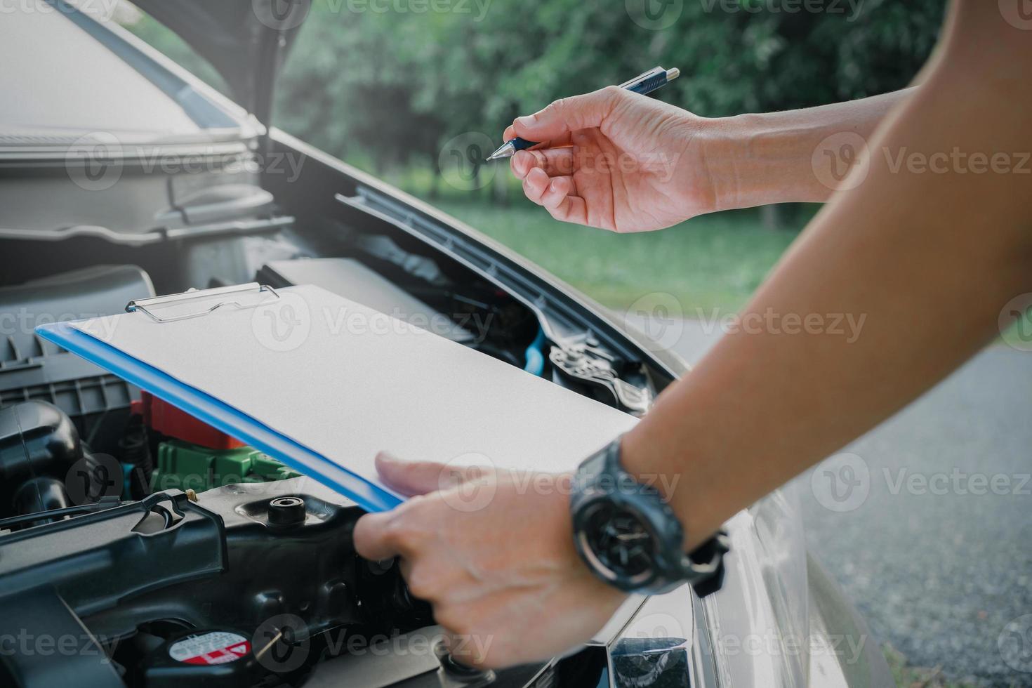 Employees Onsite concept Employees woman of the car service checking list on the paper note for maintenance and service of broken car woman the car service center  for maintenance and service car photo