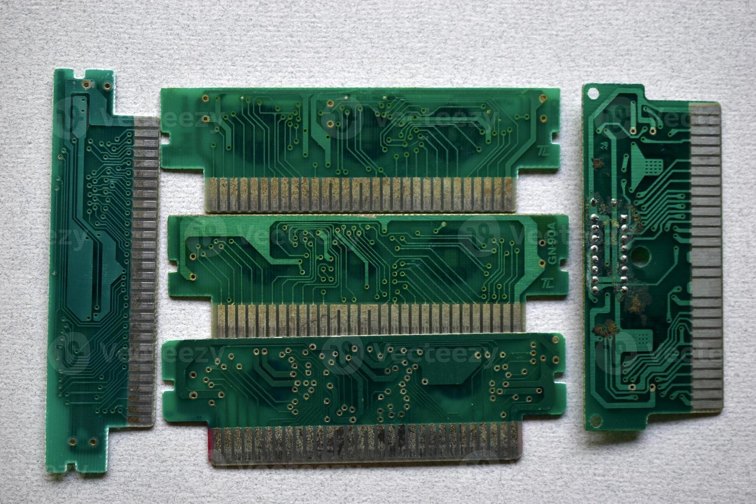 Old electronic boards for retro games. Cartridges for retro game consoles. photo