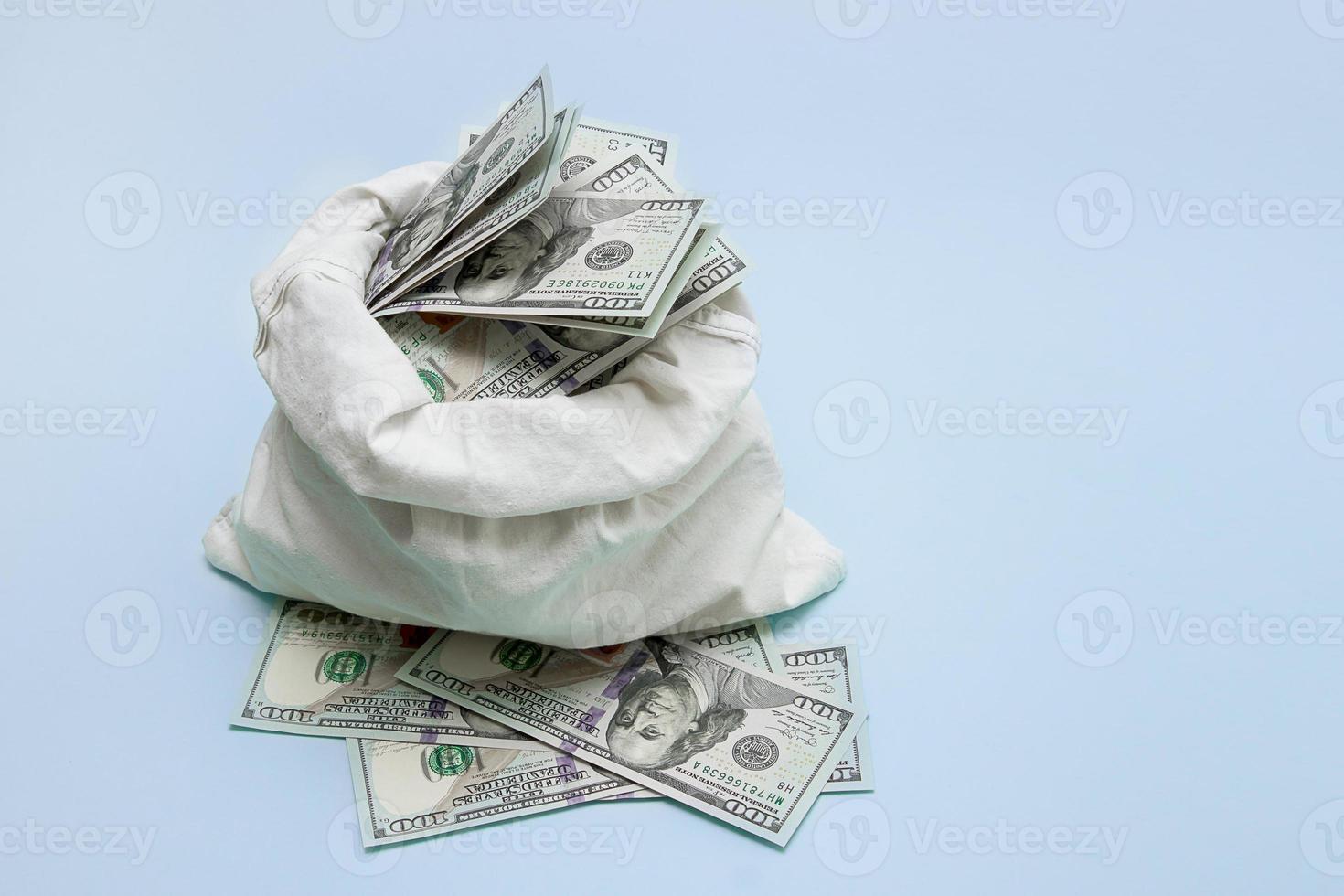 A bag of money on a blue background with a place for text, the concept of finance, business, bribe, ransom photo