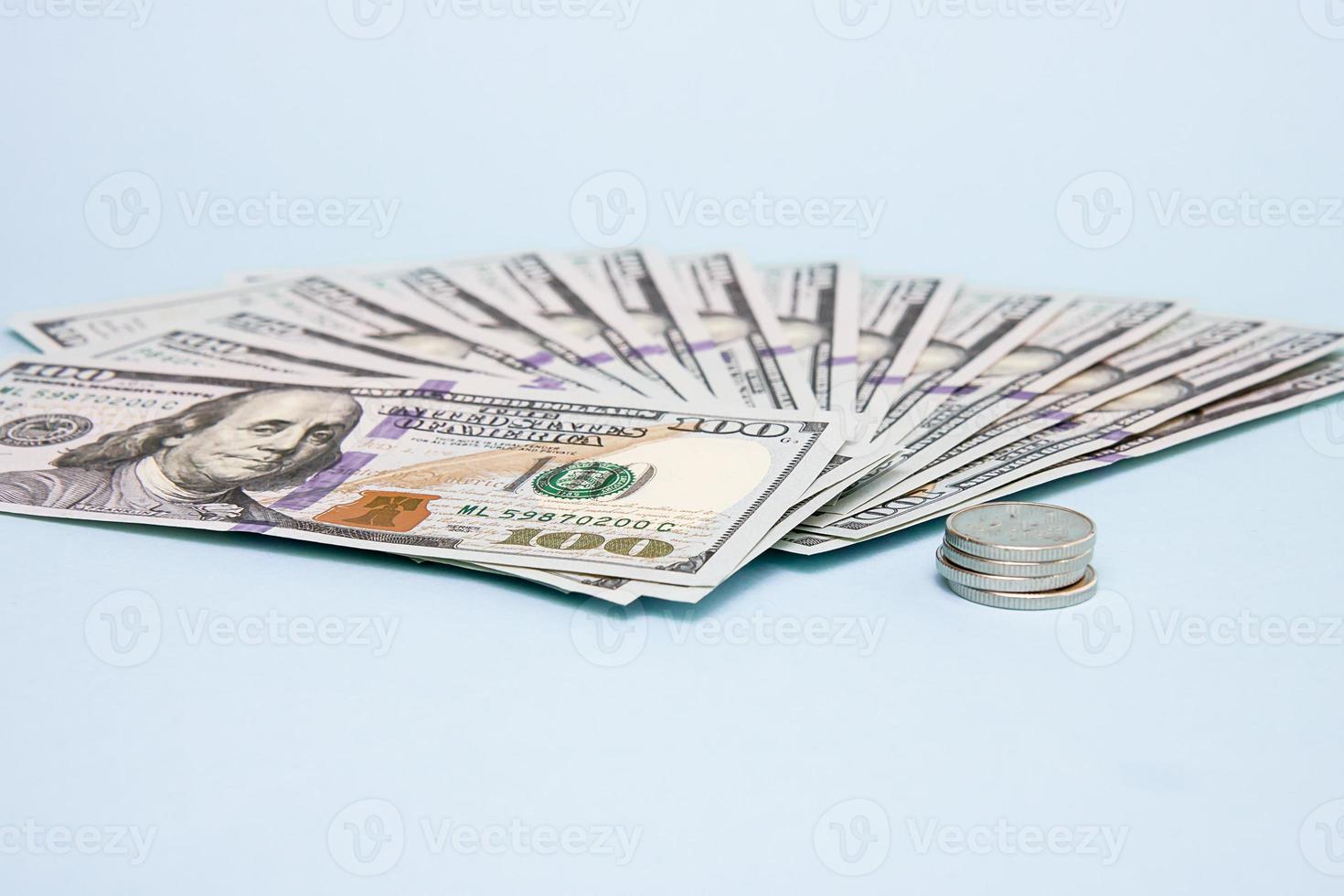 Money is fanned out on a blue background, a row of coins, the concept of business, finance, calculation, bribe photo