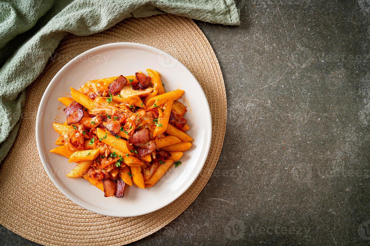 stir-fried penne pasta with kimchi and bacon photo