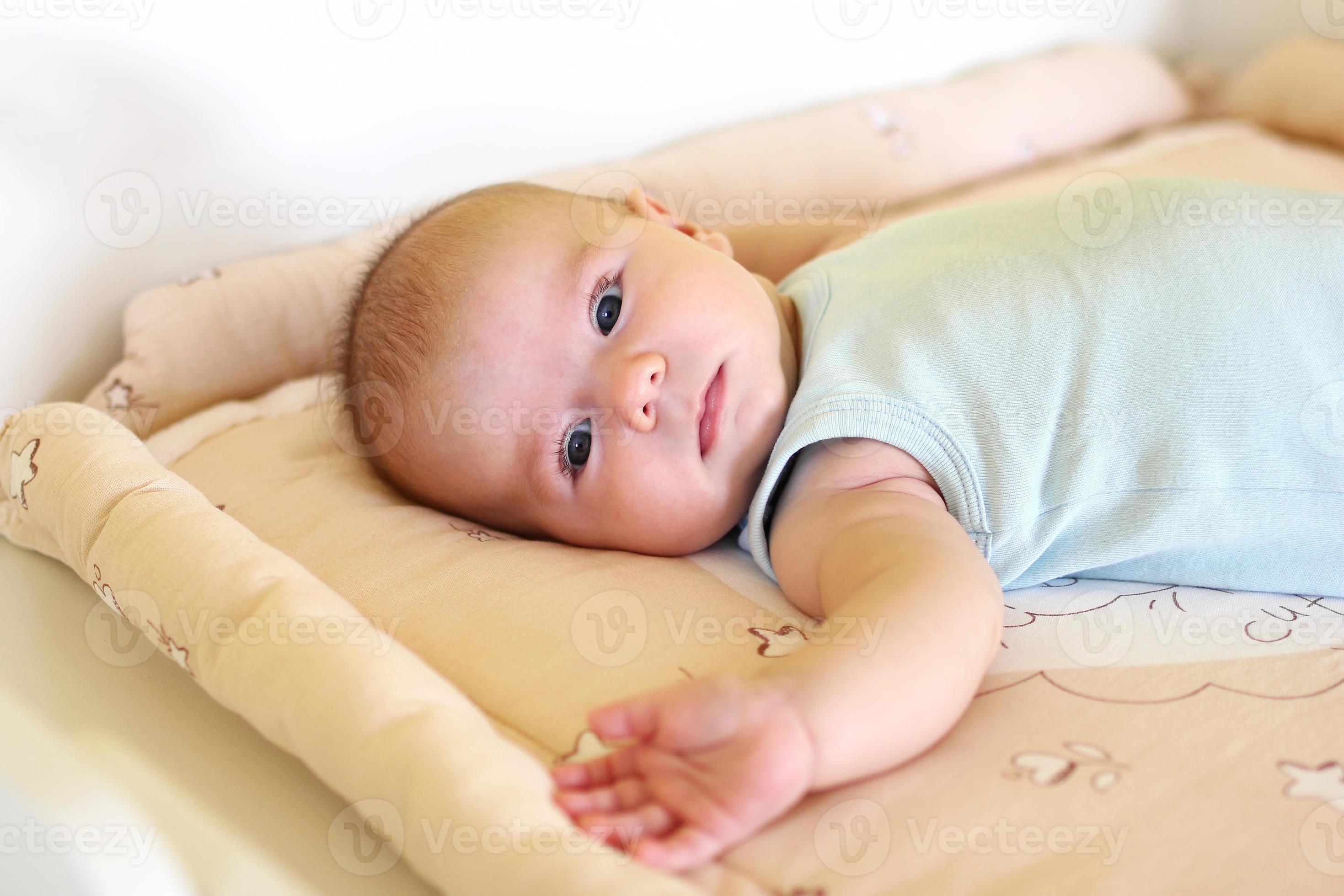 Newborn baby girl is lying on changing table. 13375086 Stock Photo at