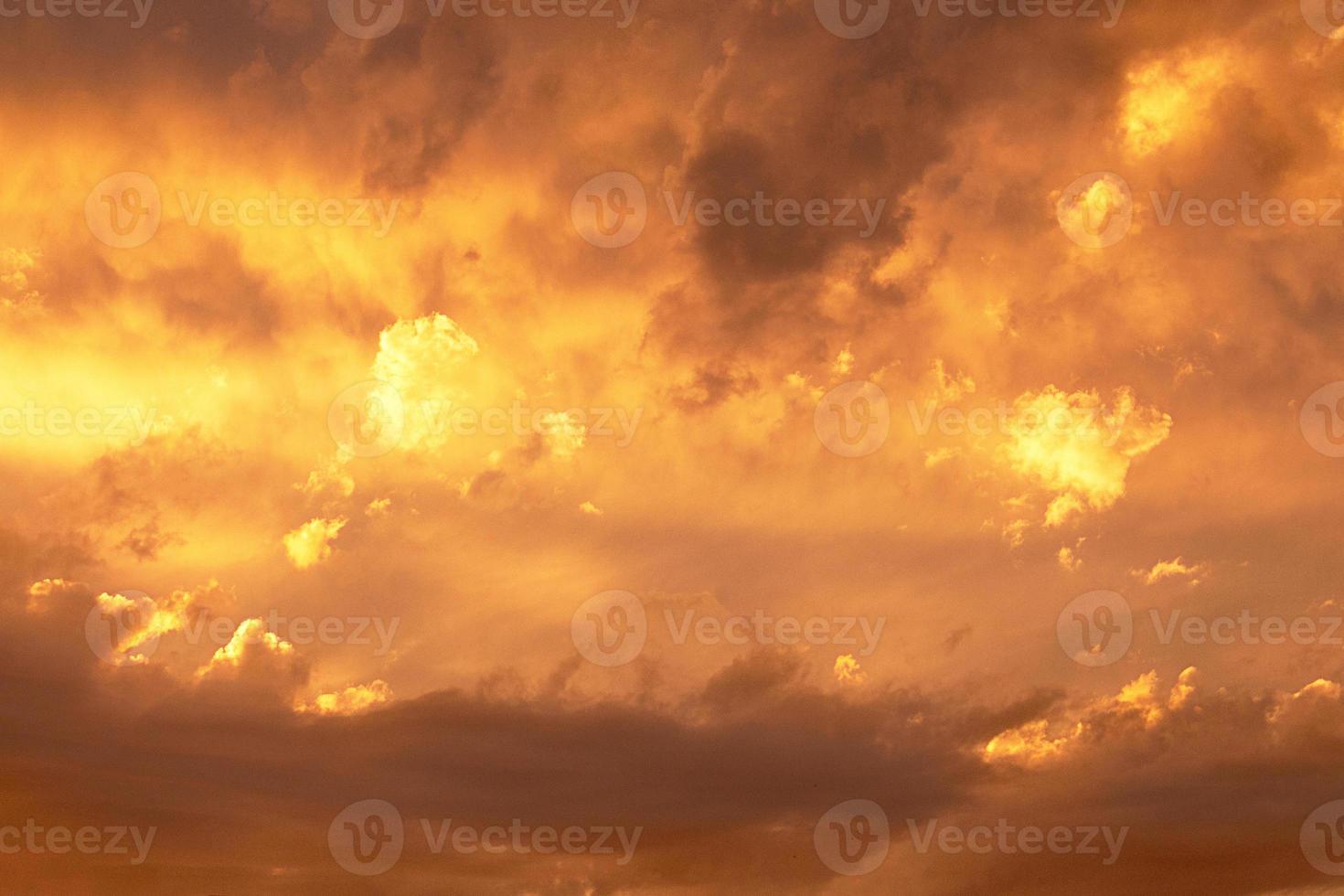 Sunset or dawn sky, yellow clouds with rays and hidden sun. Heaven high Copy space photo
