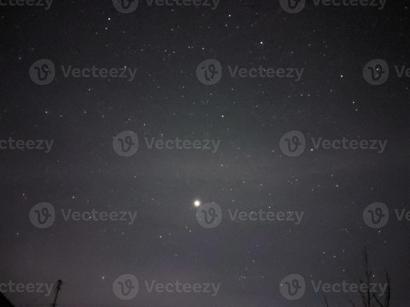 Bright night starry sky in the village photo