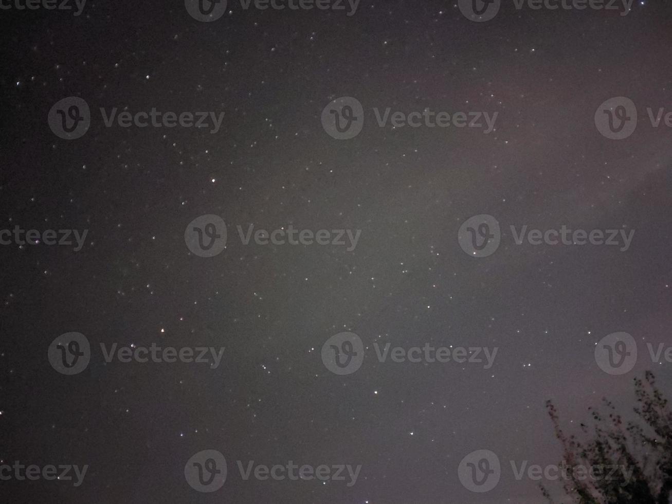 Bright night starry sky in the village photo