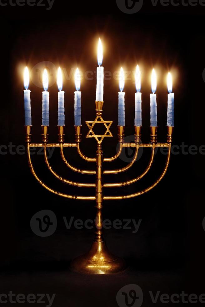 Hanukkah Menorah Brightly Lit on a Black Background photo