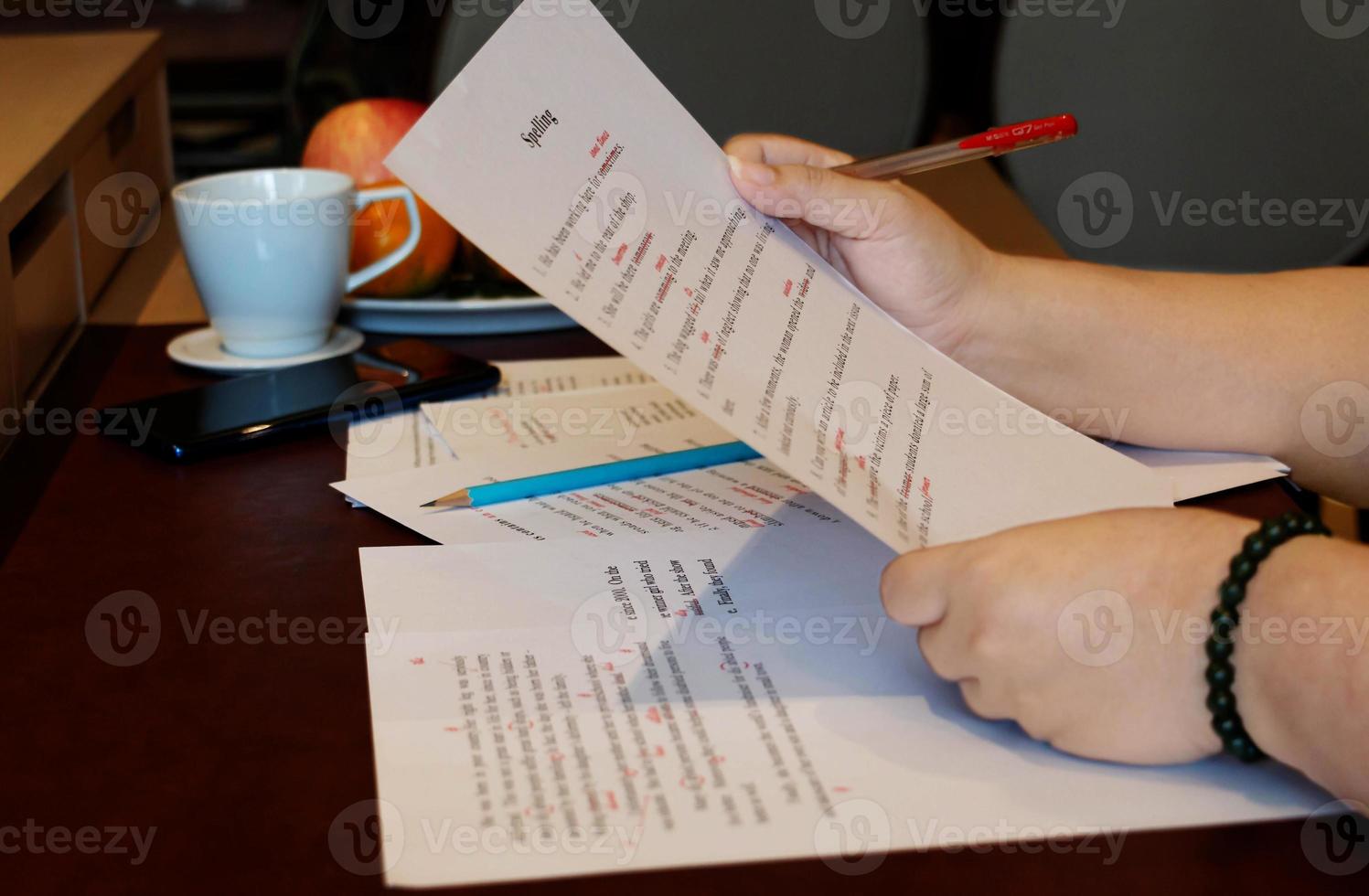 proofreading paper on table photo