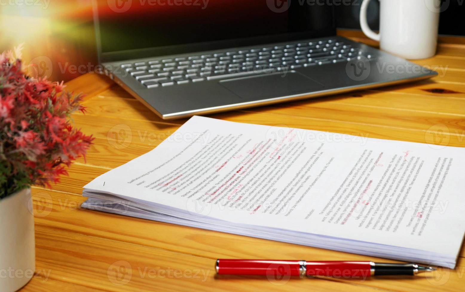 proofreading paper on table photo