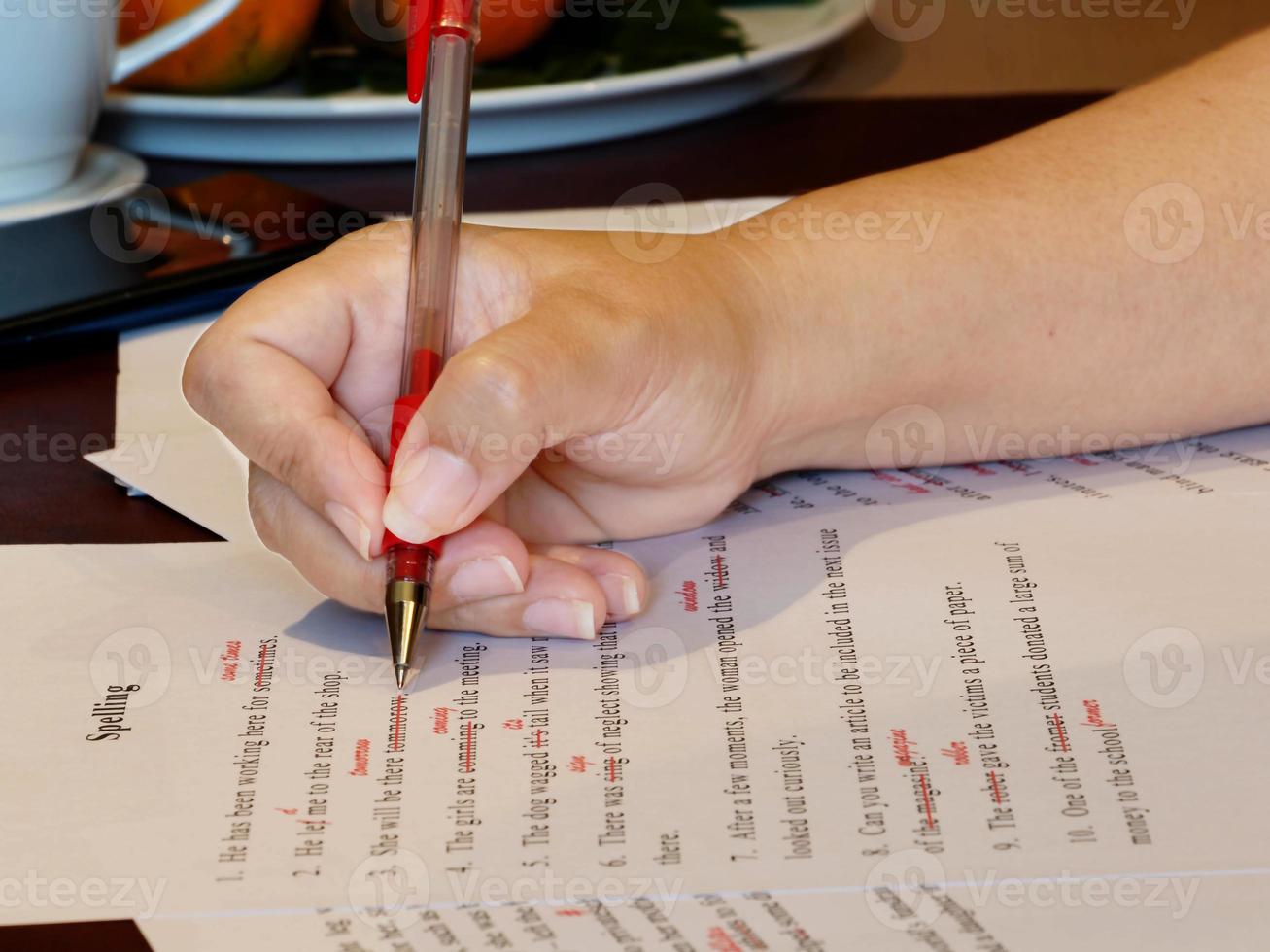 proofreading paper on table photo