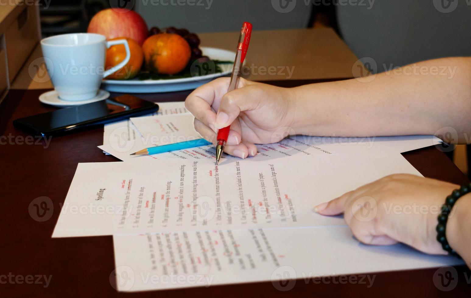 proofreading paper on table photo