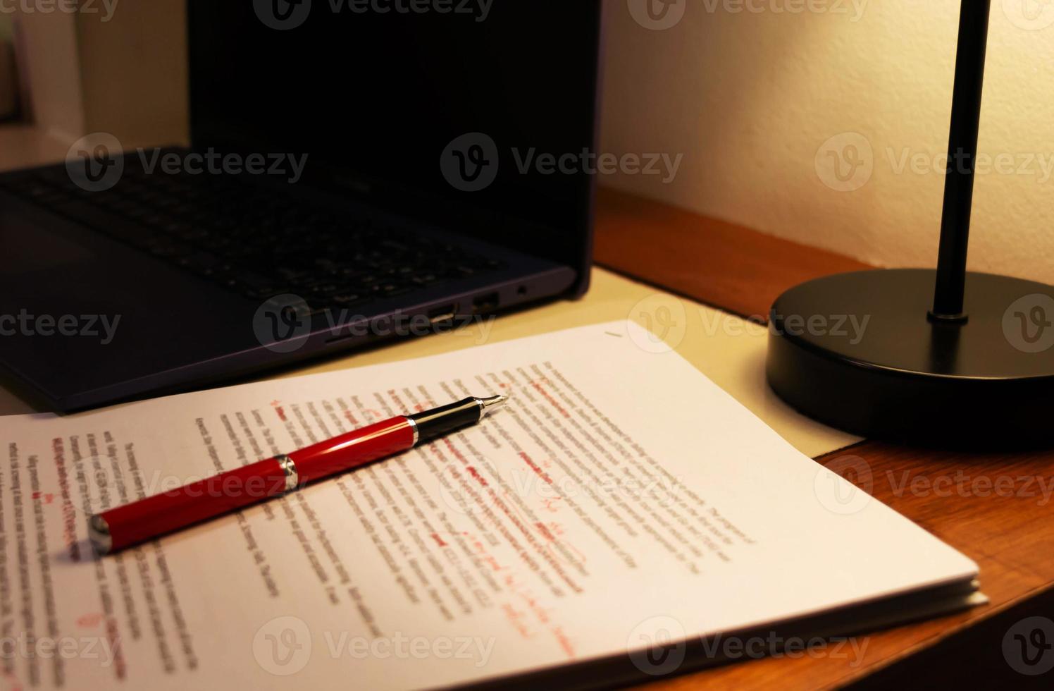 blur proofreading paper on table photo