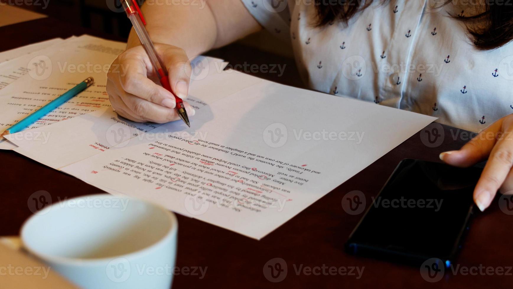 proofreading paper on table photo