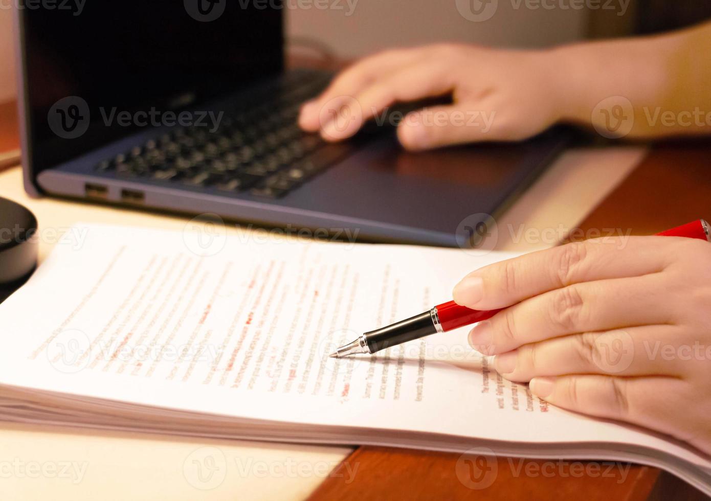 blur proofreading paper on table photo