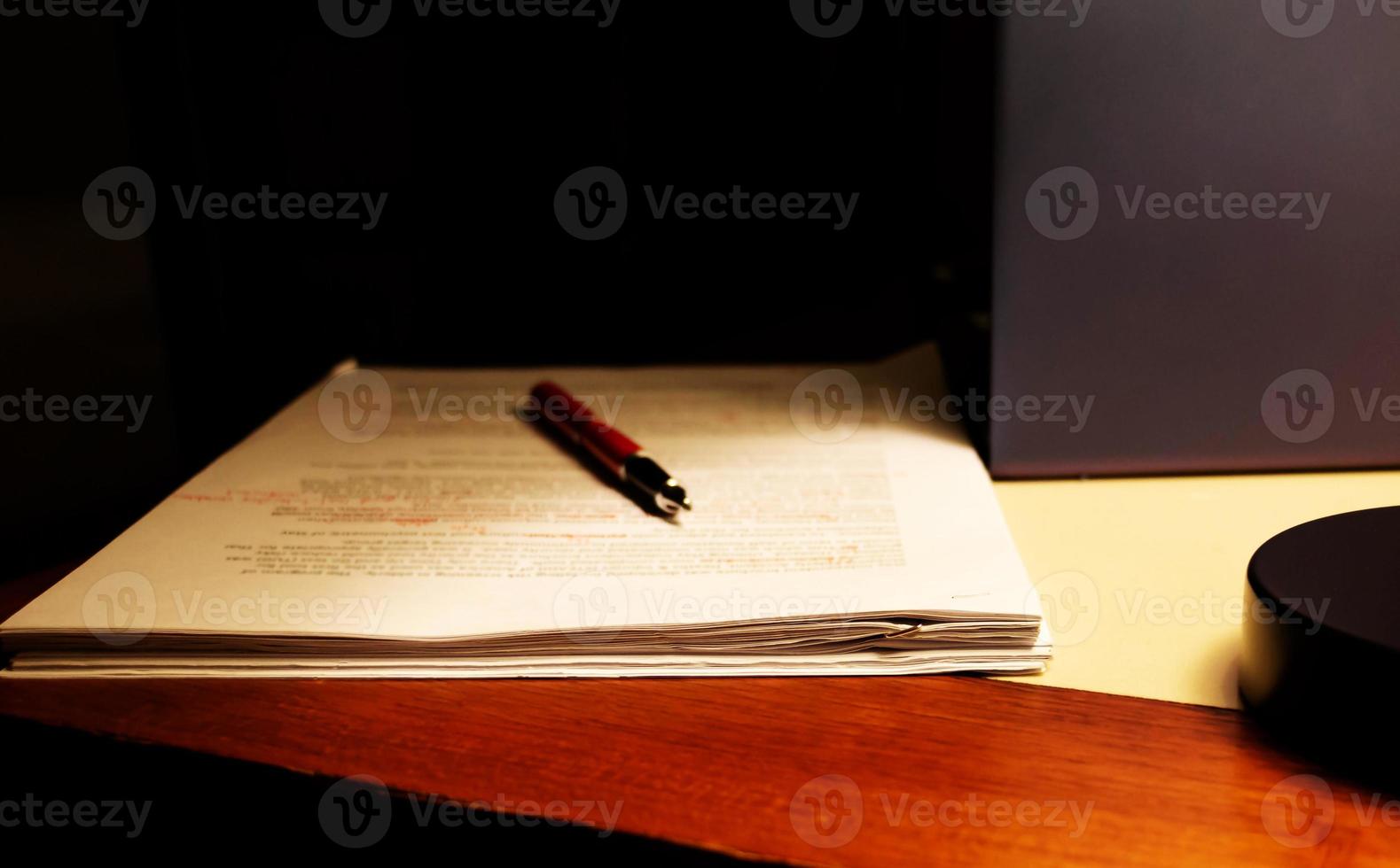 blur proofreading paper on table photo