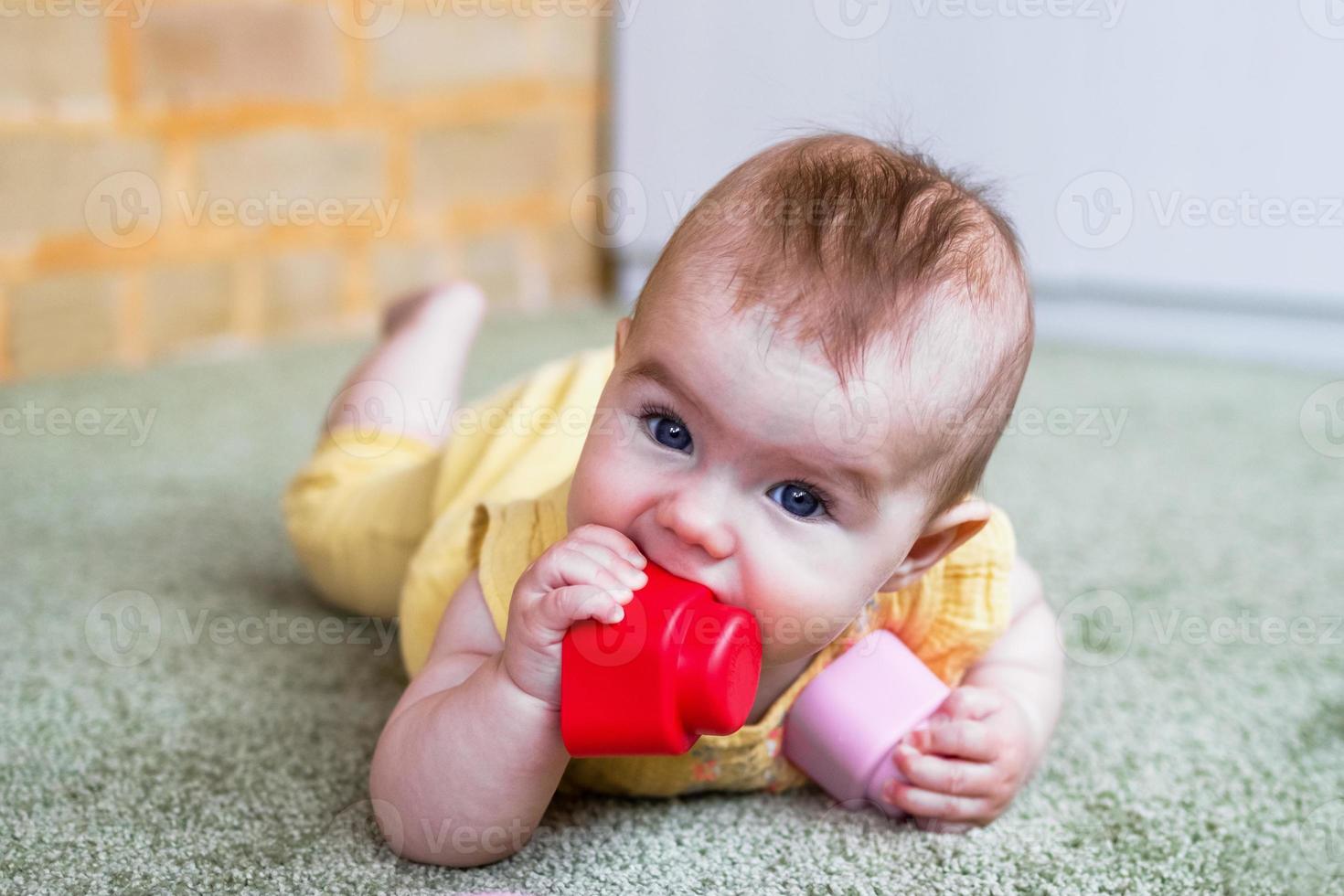 niña caucásica jugando con un constructor de plástico blando en casa. foto