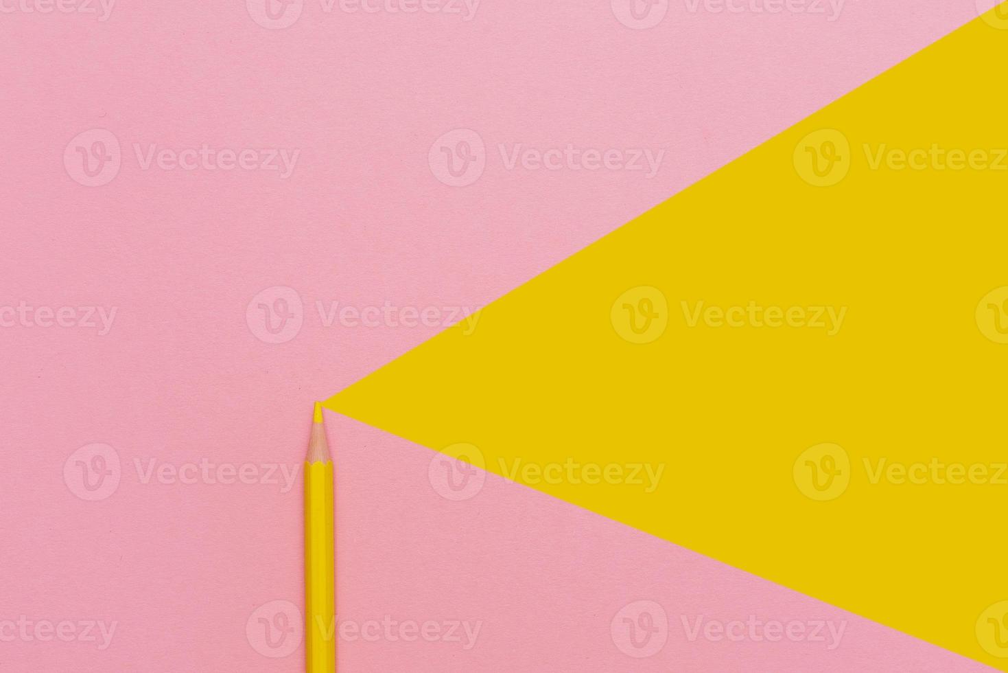 Template with copy space of wooden yellow pencil on pink paper photo