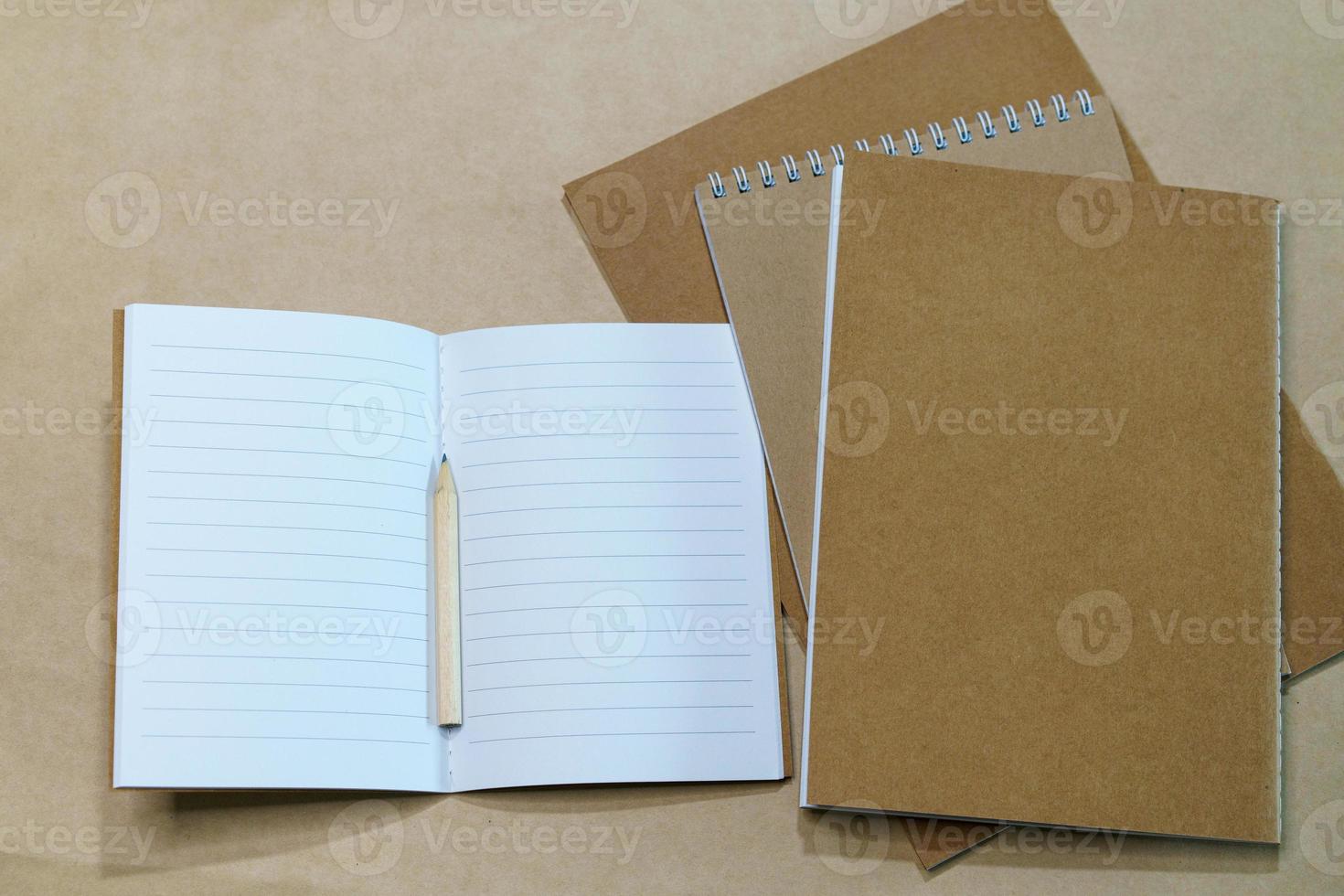 Blank white notepad and pencil on paper background. Mock up, top view, copy photo