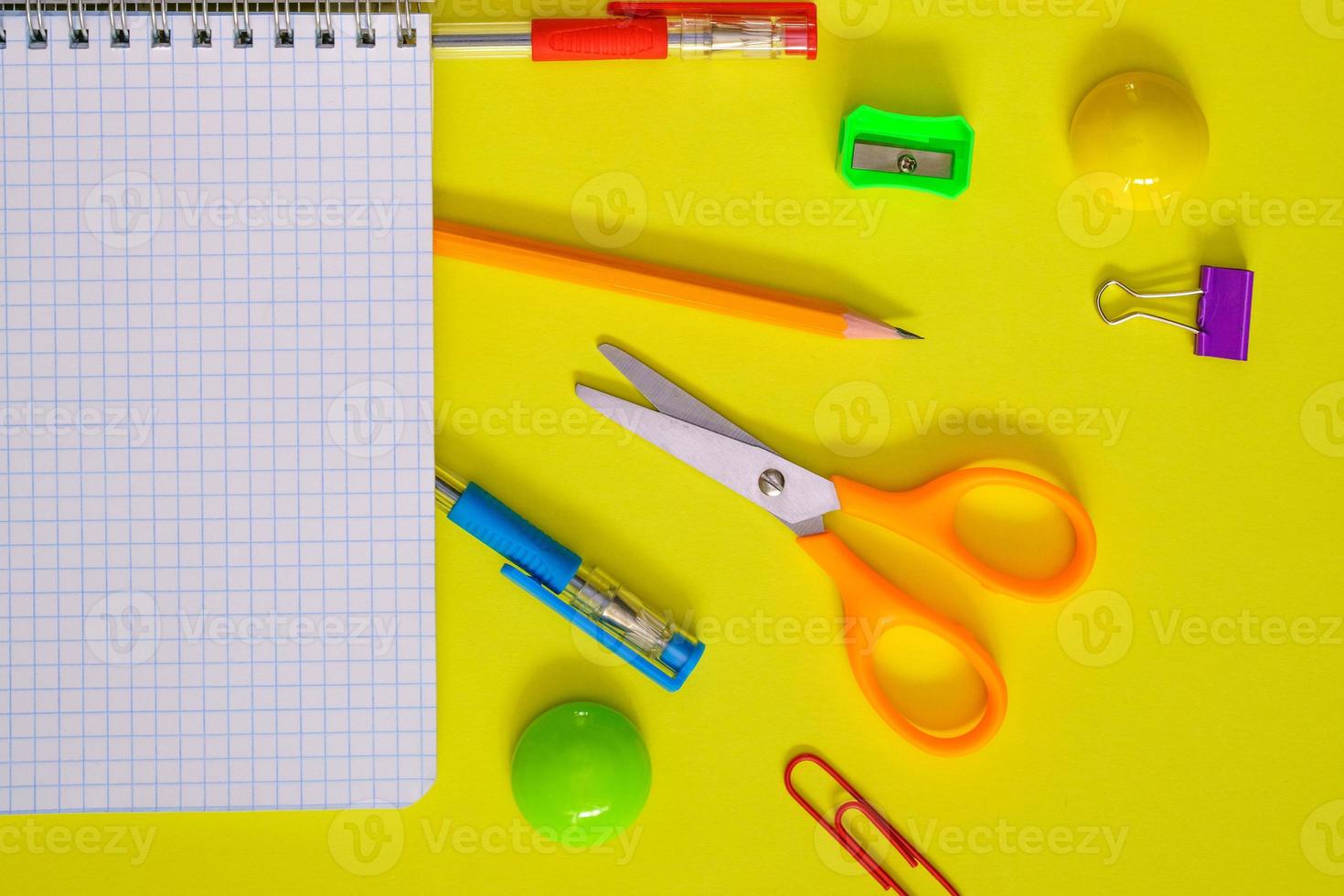 School notebook and various stationery. Back to school concept. Pencils pens photo