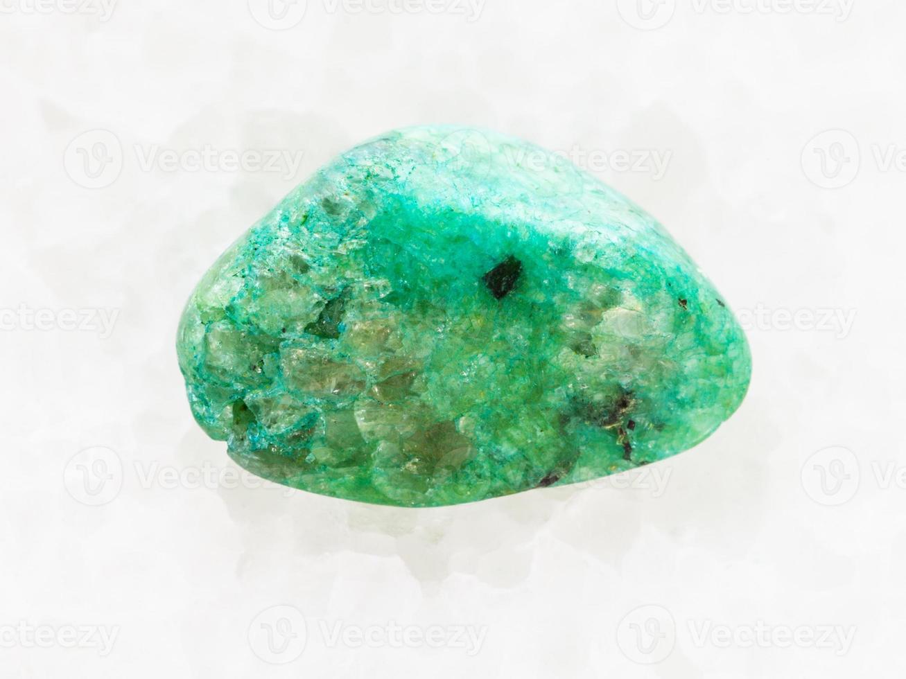 pebble of green Agate gemstone on white marble photo