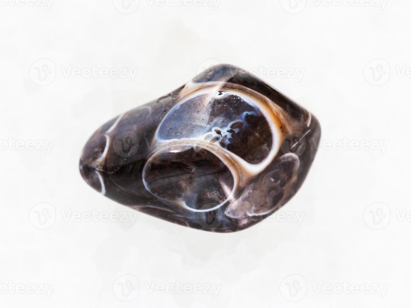 polished Turritella Agate gemstone on white marble photo