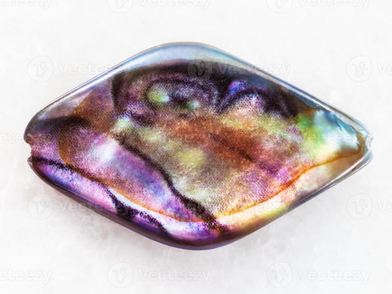 bead from Abalone haliotis shell on white marble photo
