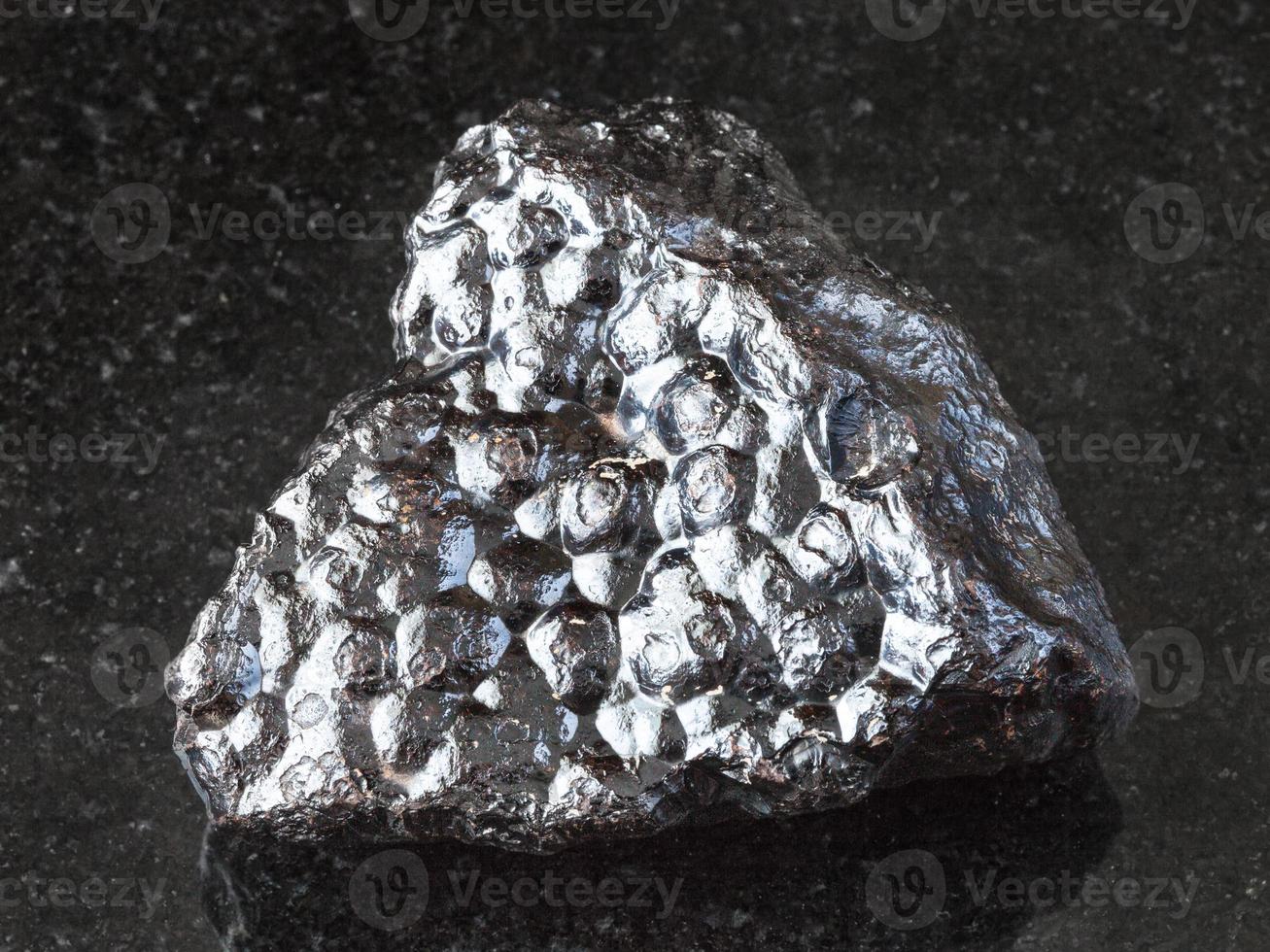 raw Hematite Kidney Ore stone on black photo