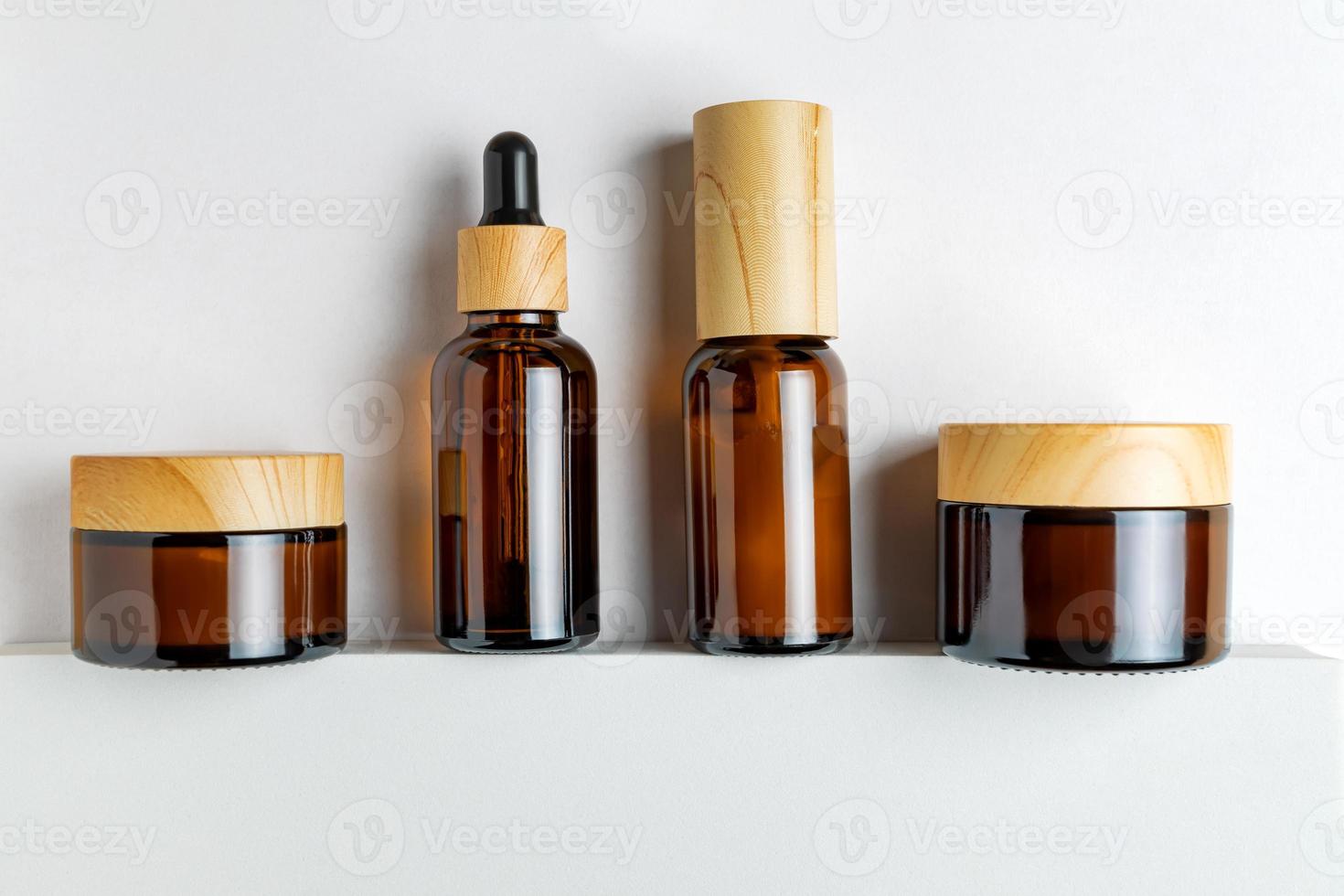 Set of unbranded bottles and jars of dark glass for cosmetics. on white background. Skin care concept. Mockup photo