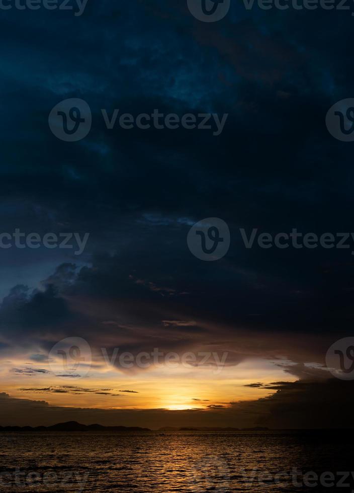 Sunset Dusk Sky in Evening with Orange,Yellow and Dark blue colour by the sea, Seaside with dramatic twilight landscape of Skyline and cloud,Vertical Romantic Sunrise in Summer photo