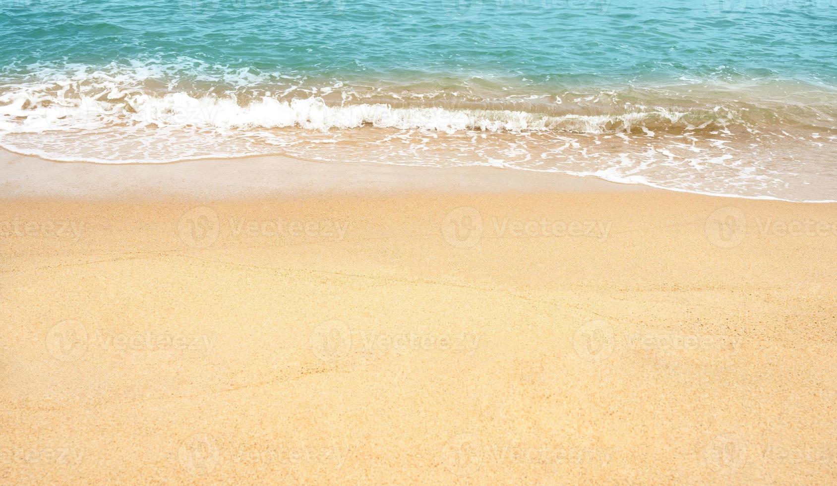 Sand beach and Blue ocean with soft wave form on Sand Texture, Seaside view of Brown Beach sand dune in sunny day Spring, Holizontal top view for Summer banner background. photo