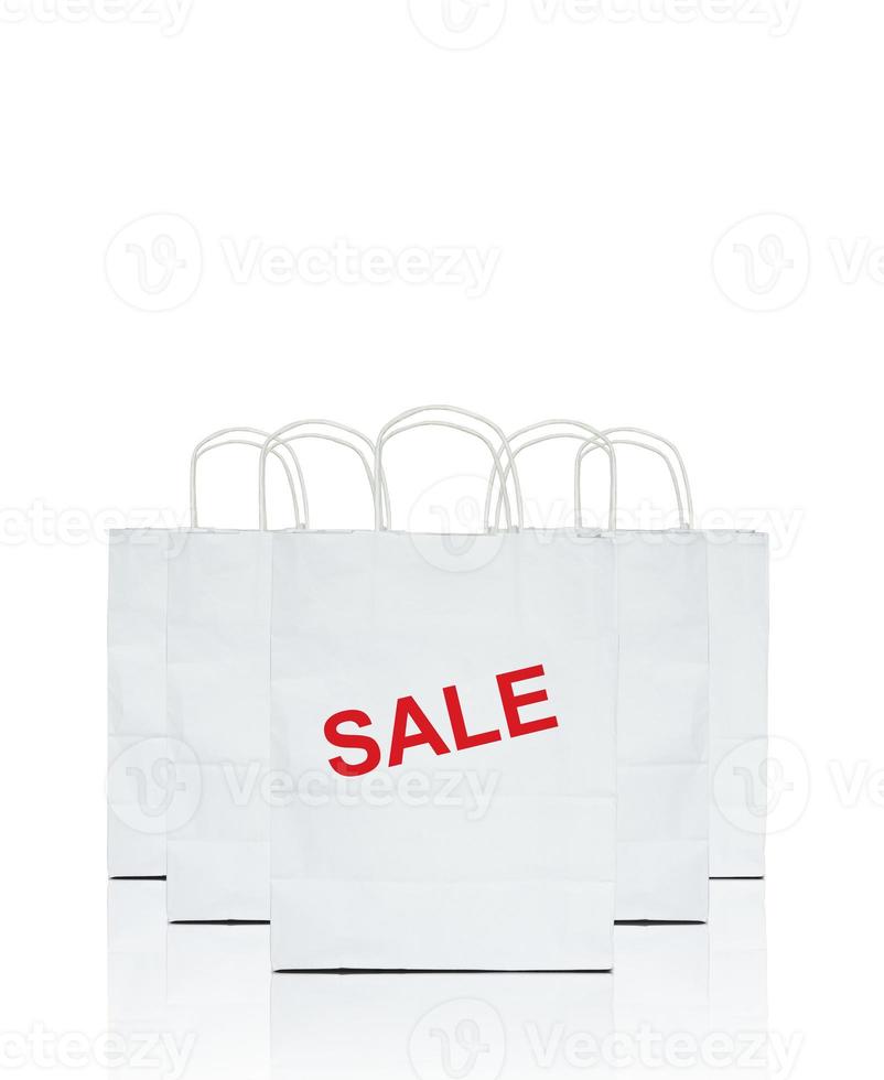 white shopping bags with the word sale on white photo