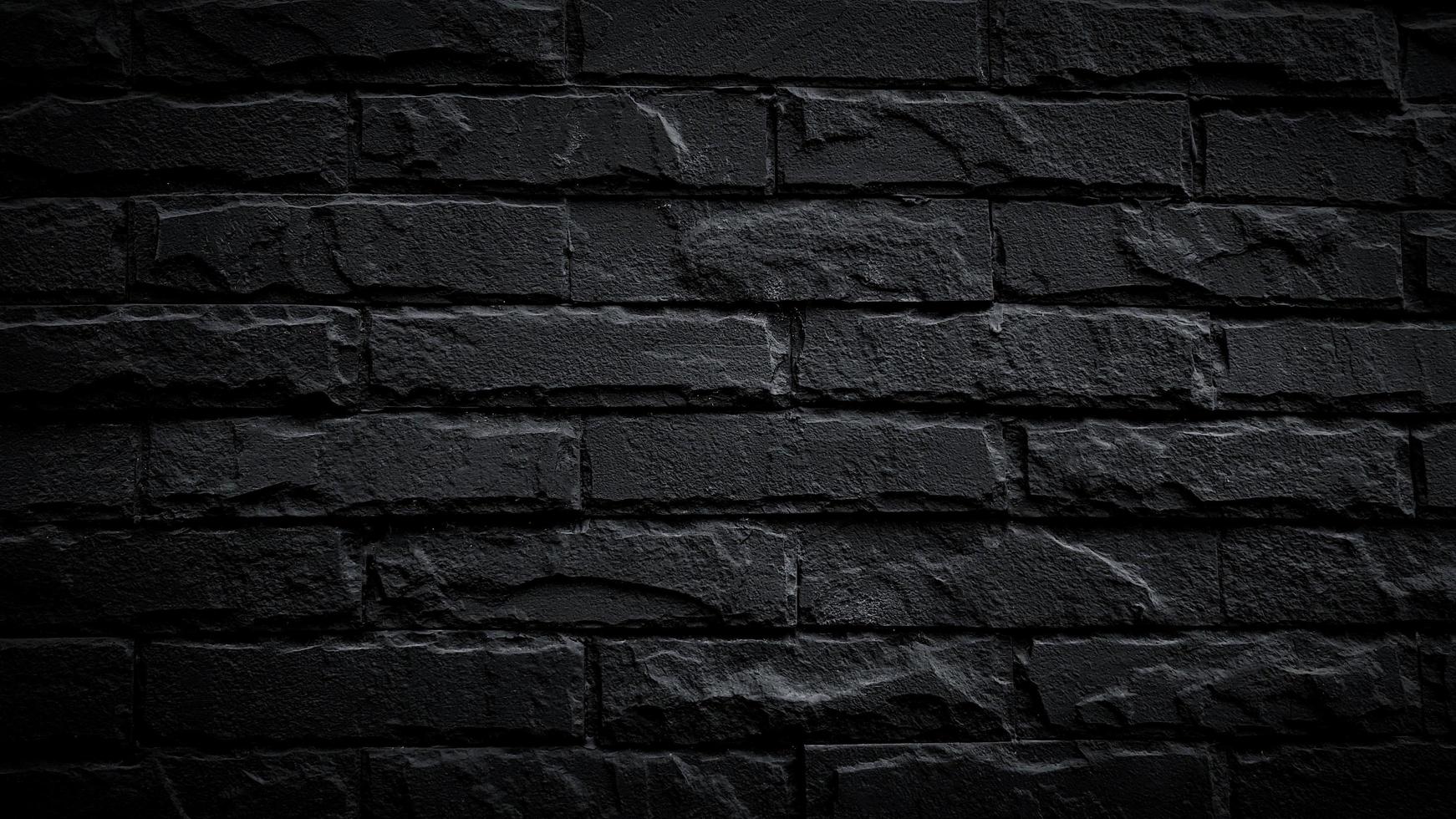 Black brick wall for background. Pattern of brickwork wallpaper and Construction building. photo