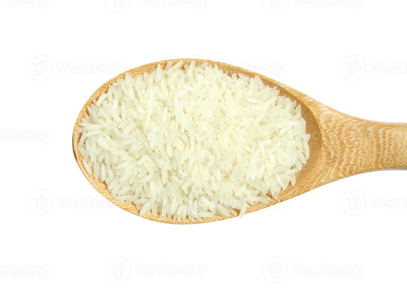 wooden spoon with rice isolated on white background photo