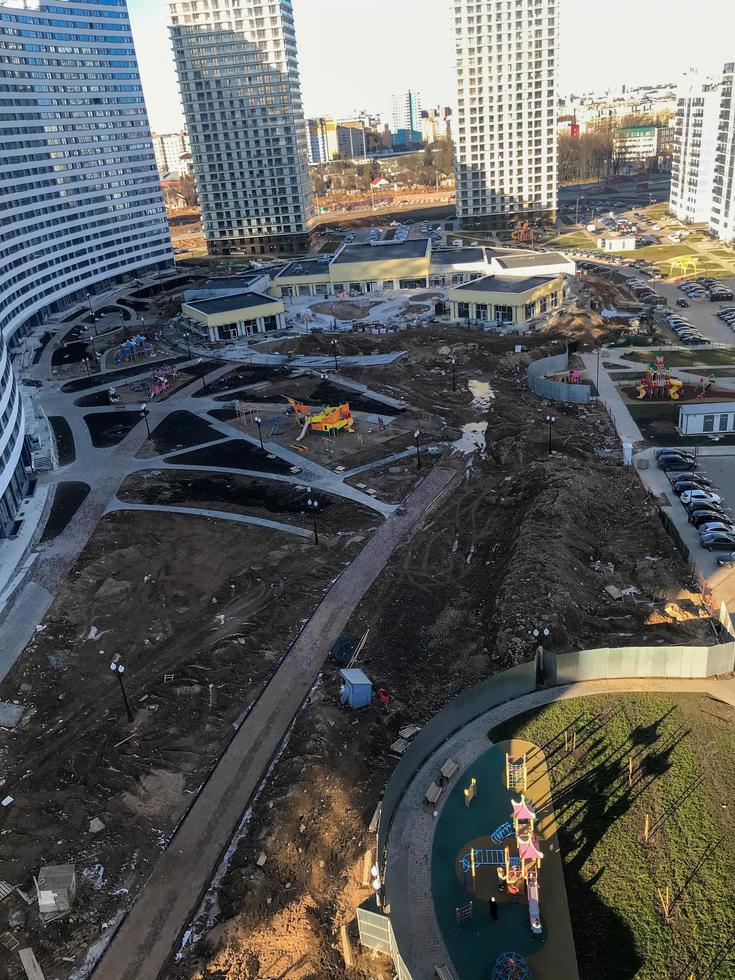 construction of a new area. bird's-eye view. construction of playgrounds. tall houses, white and blue. lawn areas for playing with pets and children. small shopping center photo