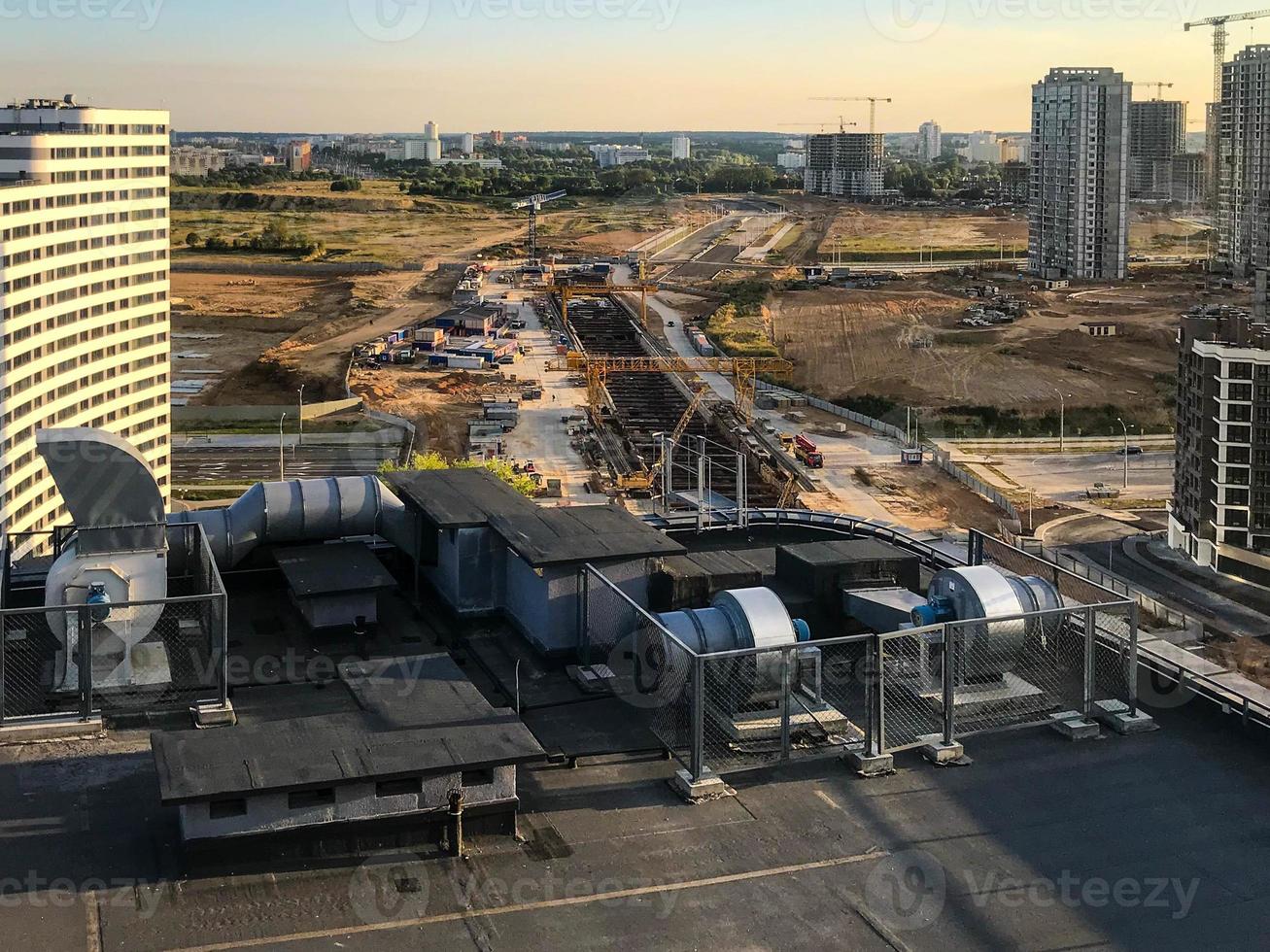 there is a technical room on the roof of a multi-storey building. a transformer box was installed, electricity supply to the house. against the background of high-rise buildings photo