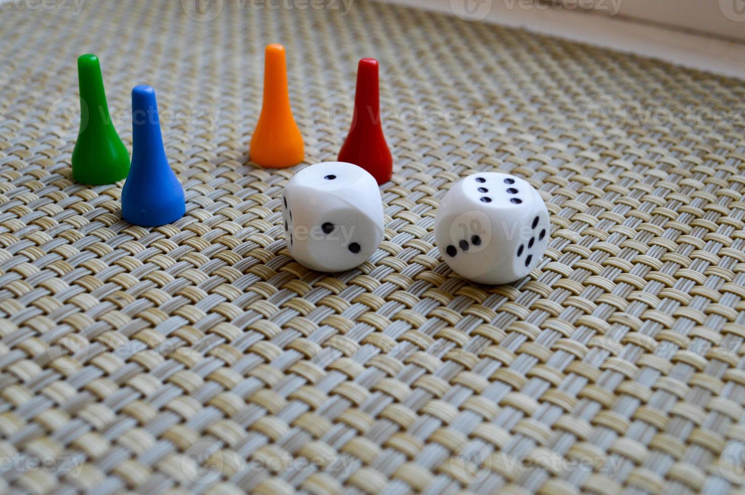 White dice, dice and four chips for board games. photo
