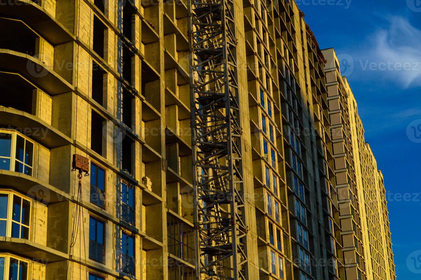 demolition of a multi-storey building. a large concrete house with glass windows is about to be demolished. destruction of high-rise buildings. creating additional space for building a house photo