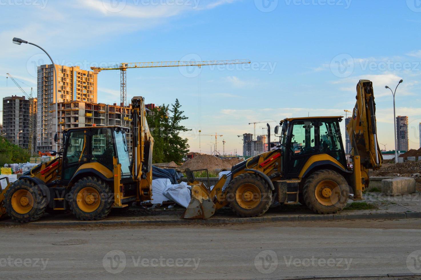 construction machinery builds in the city center. excavators for excavating sand and making foundations. yellow big construction equipment to create a new quarter in the city photo