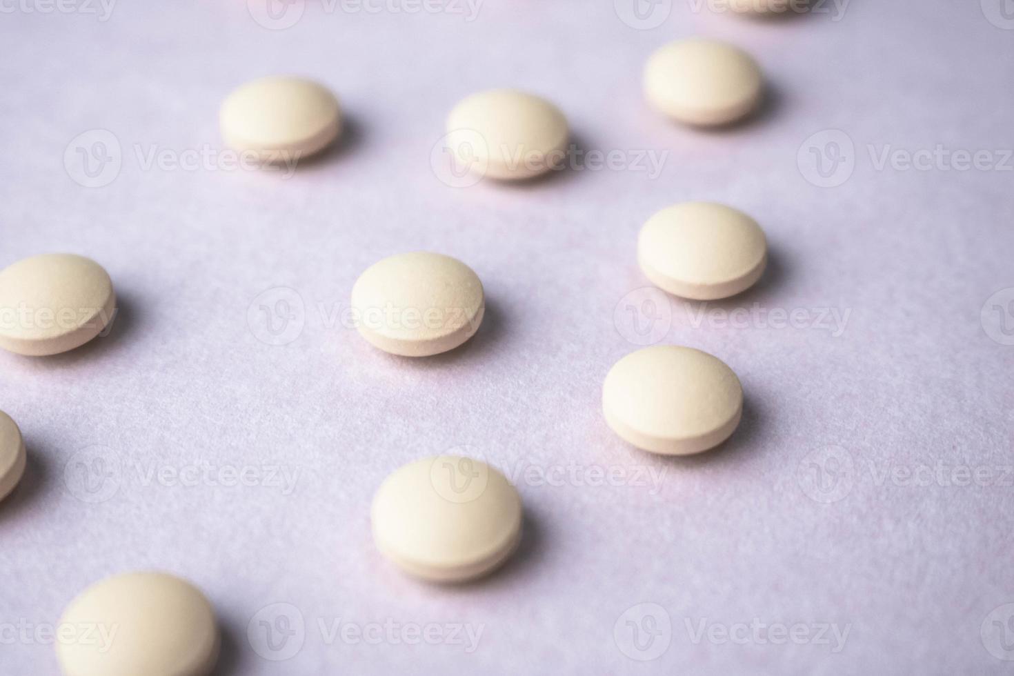 Little beautiful medical pharmaceptic round pills, vitamins, drugs, antibiotics on a black and white background, texture. Concept medicine, health care. Flat lay, top view photo