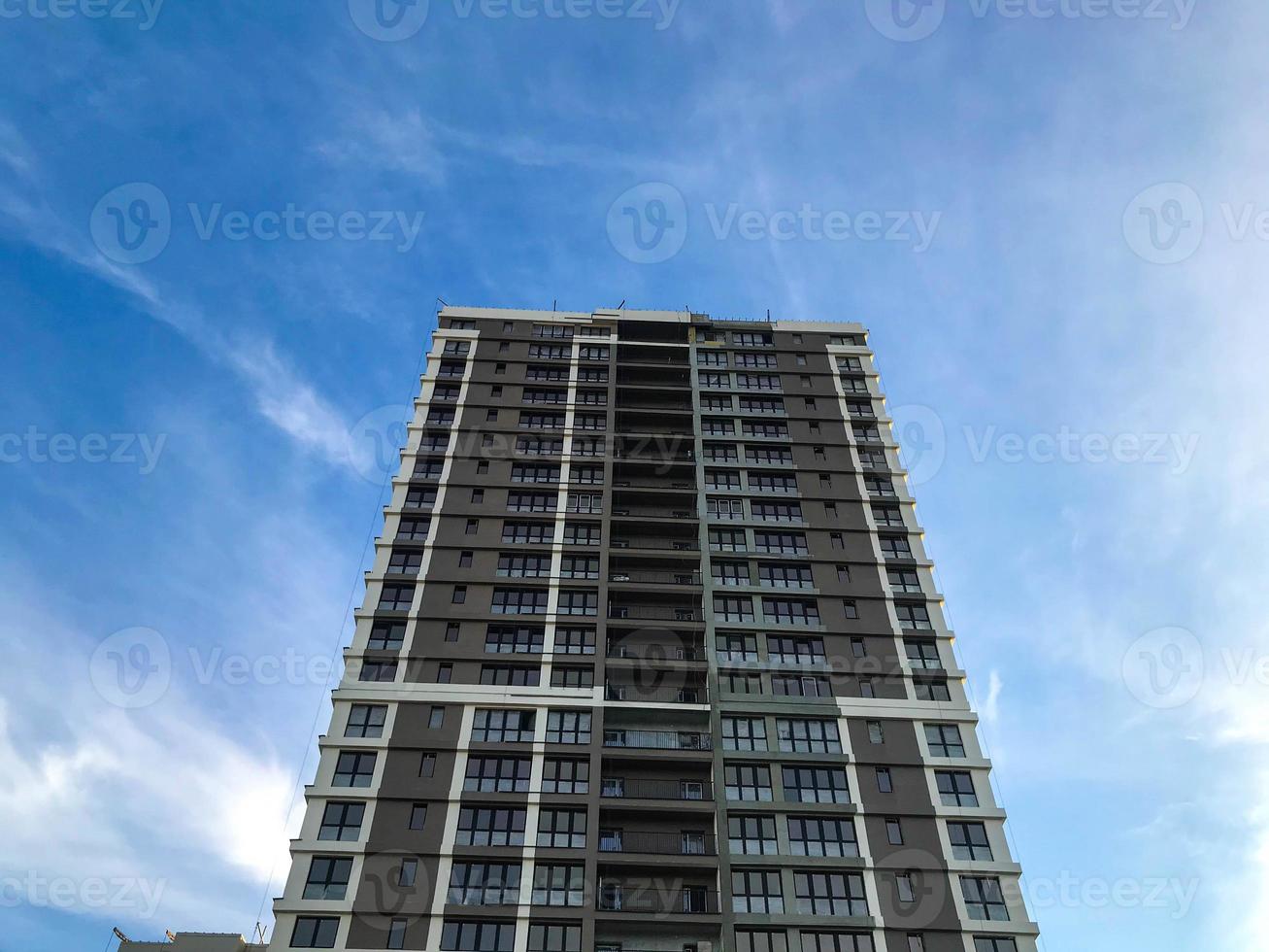 multi-storey building, brown and white decoration. black frames in the windows, panoramic glazing. a tall building for an ergonomic life, a comfortable and cozy environment photo