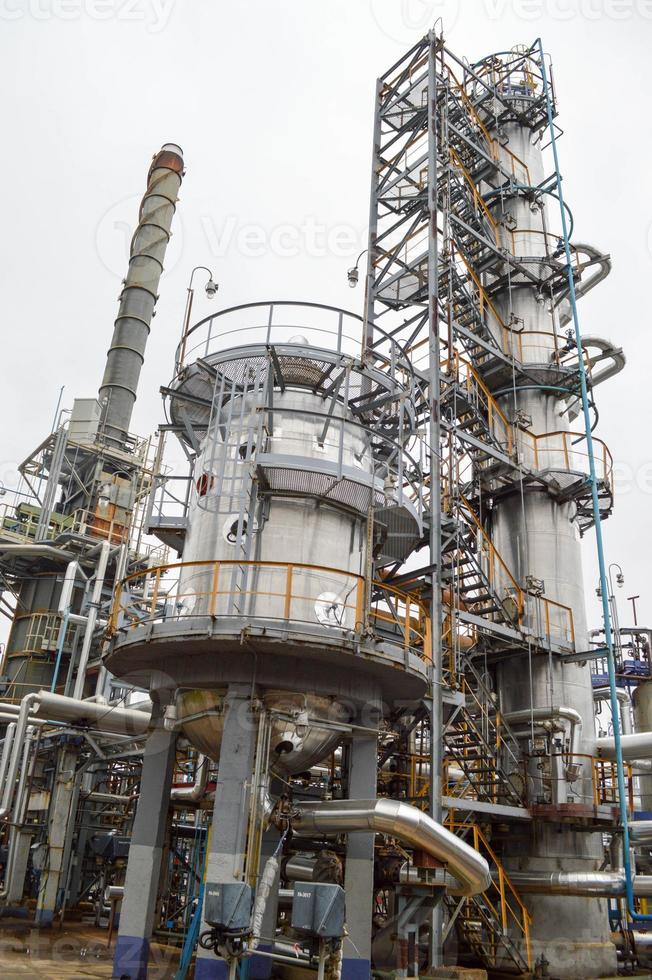 Installation for processing oil with columns and pipes. Refinery. Oil and gas. photo