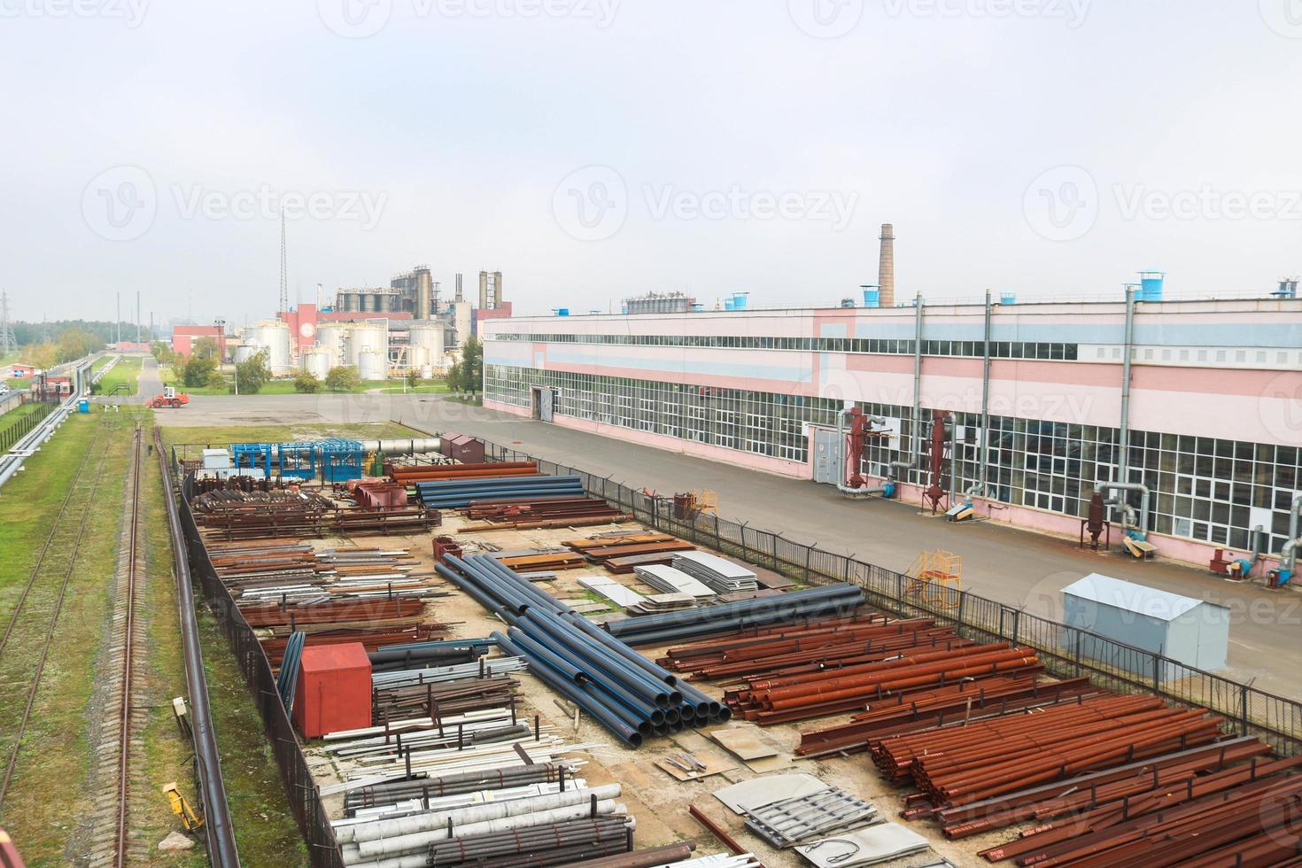 Industrial landscape. Panoramic view of the technological pipes. Rusty pipes, blue rubies, production communications. Repair buildings in production. Against the background of a misty sky photo