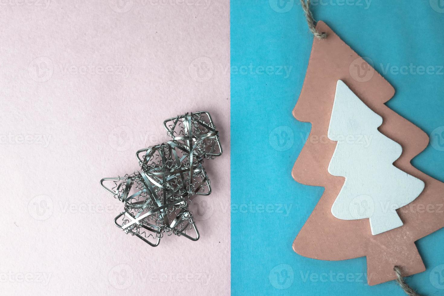 Festive New Year Christmas winter happy blue and pink beautiful joyful background with thinking little wooden and metal toy homemade tree. Flat lay. Top view. Holiday decorations. photo