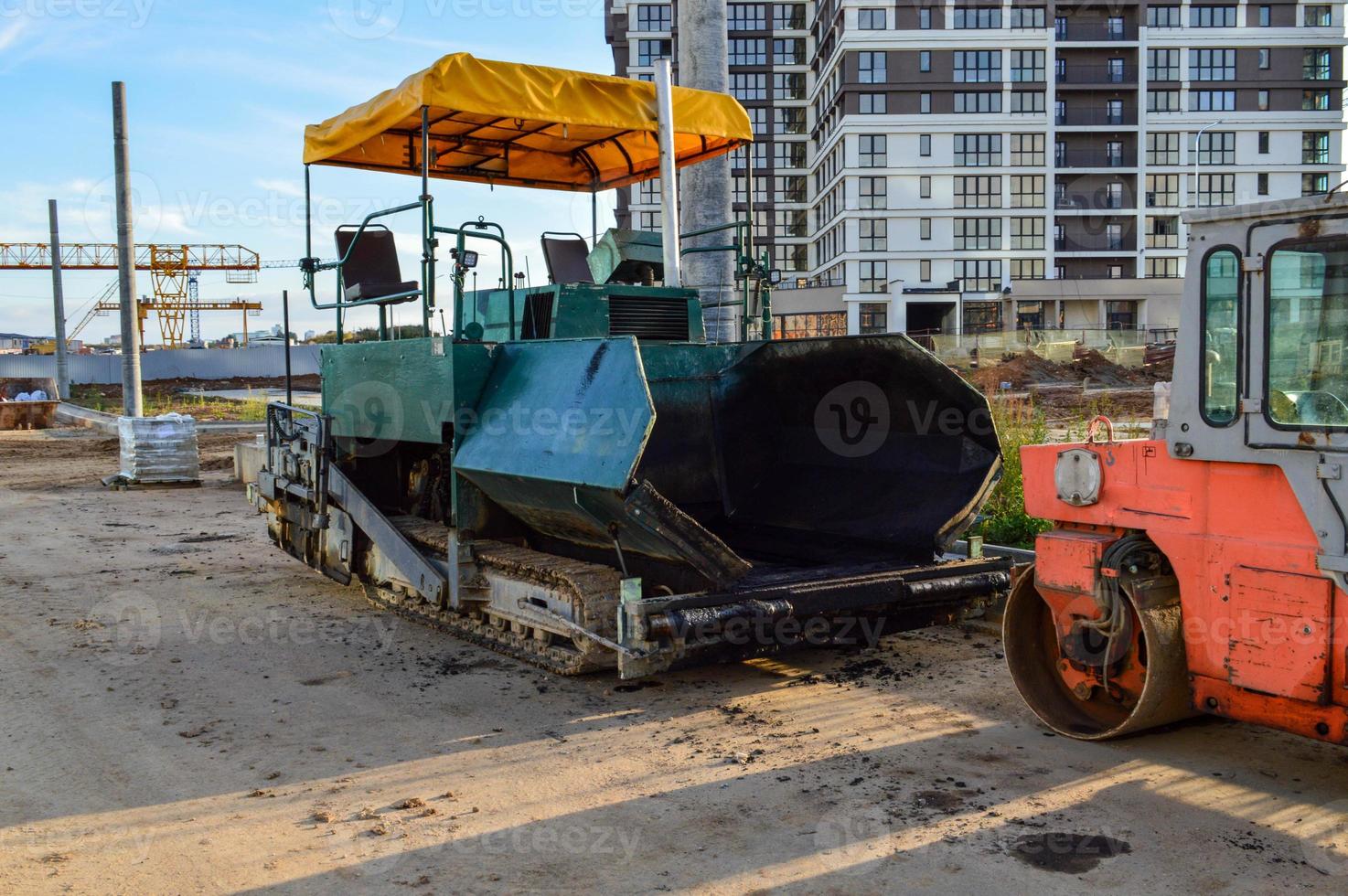 machine for creating improved coverage on the road. asphalt concrete plant for highway construction. smooth and beautiful, safe roads in the city center photo