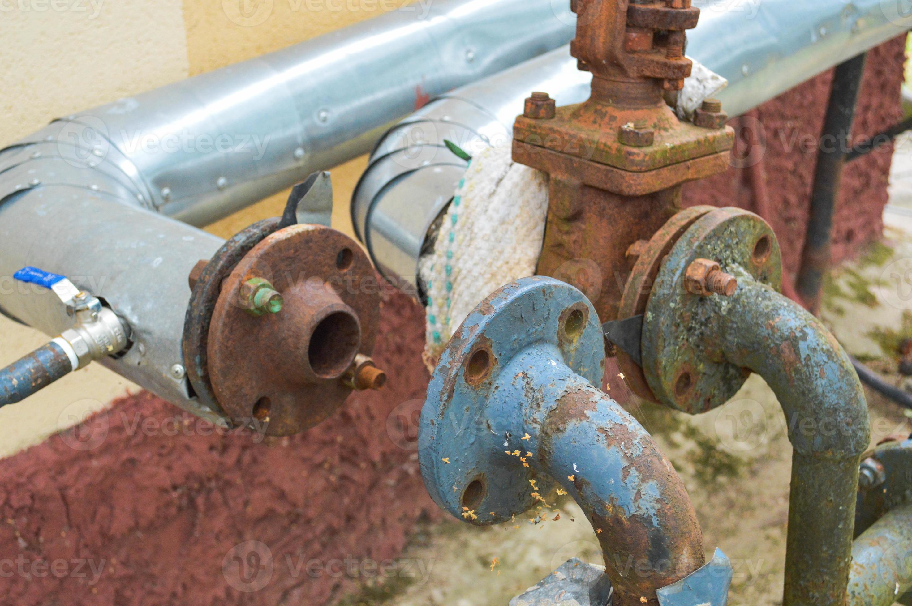 Iron old rusty corrosionproof industrial metal pipes with flanges