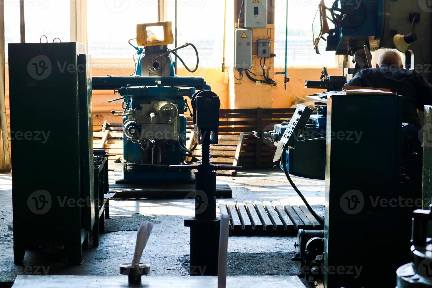 Industrial iron lathe for cutting, turning of billets from metals, wood and other materials, turning, manufacturing of details and spare parts at the factory photo