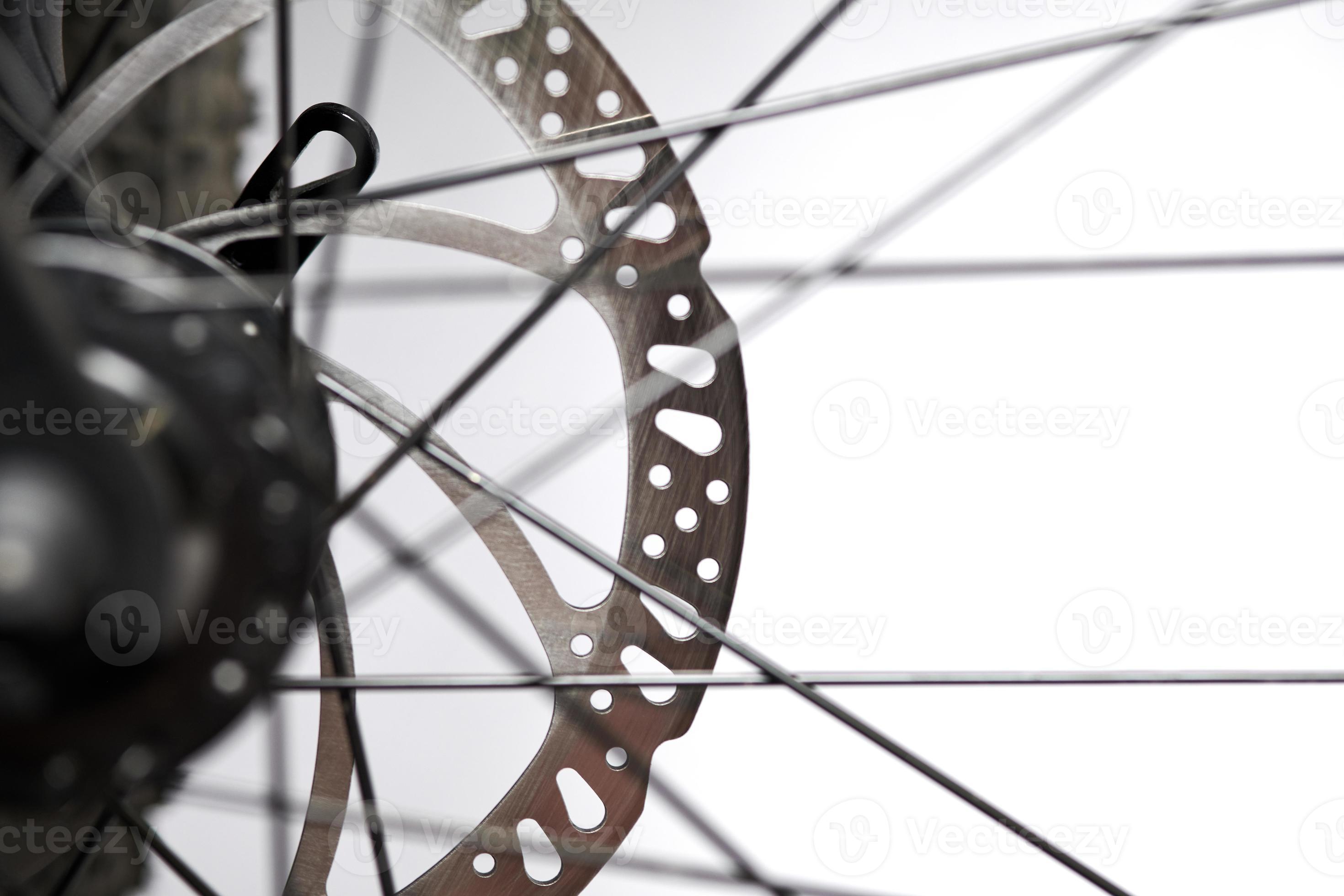 Bicycle disk brakes close up, metal disc attached to bike wheel